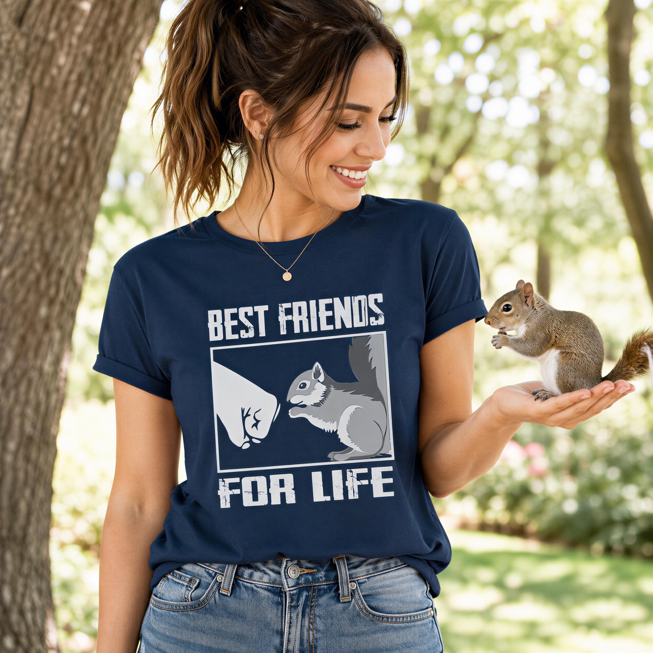 A woman in a blue t-shirt with a graphic of a squirrel and the text "Best Friends For Life" is smiling and holding a squirrel in her hand.