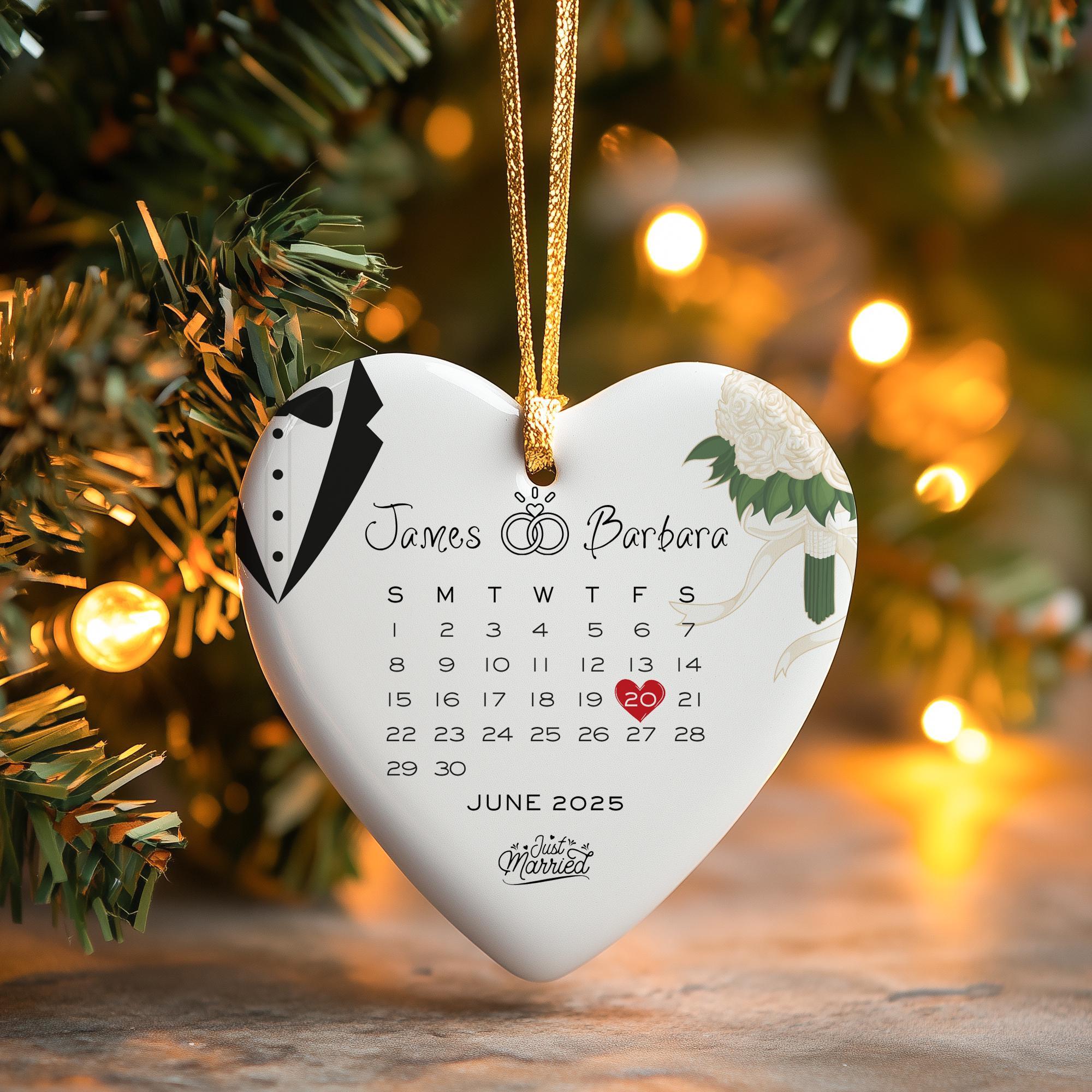 a white heart shaped ornament hanging from a christmas tree