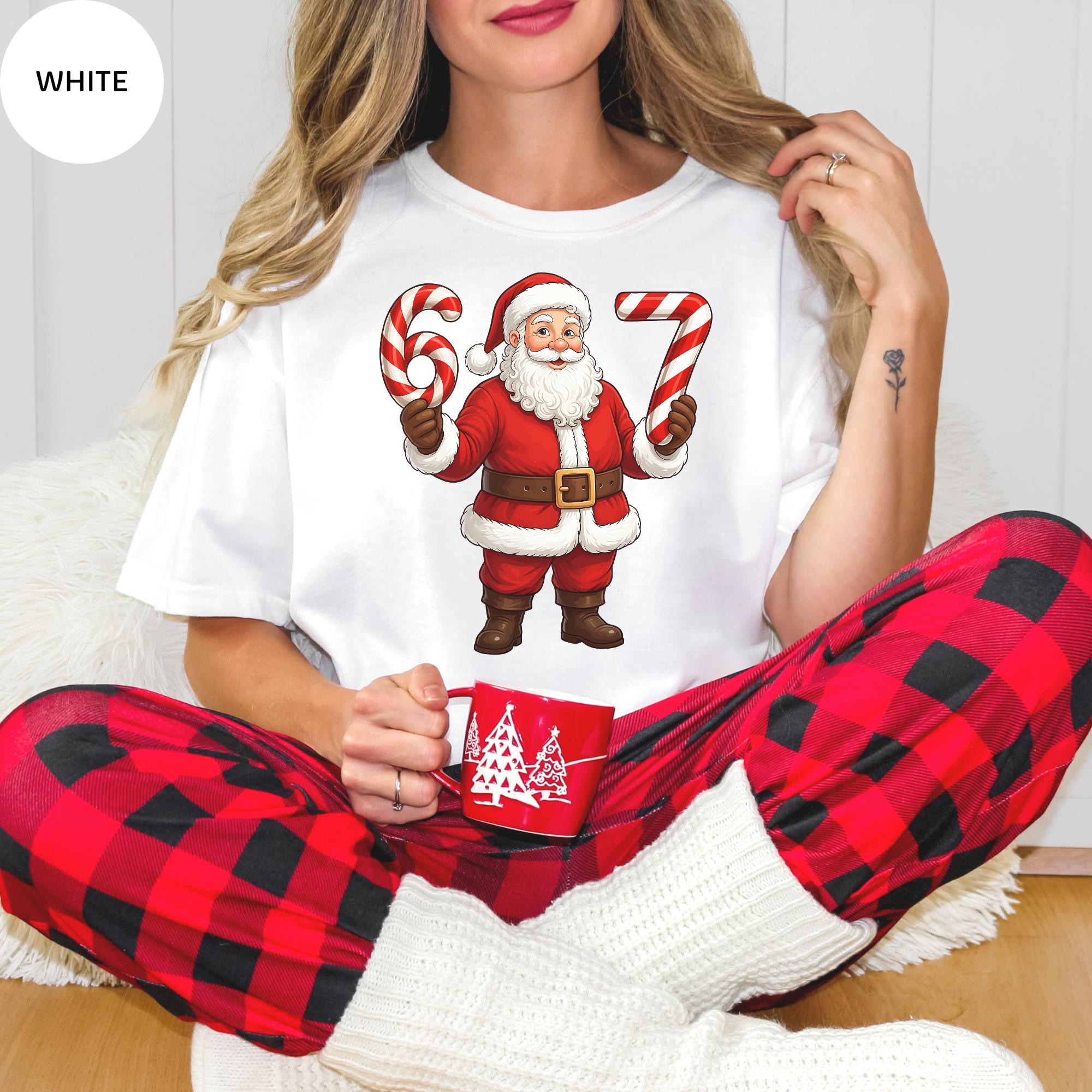 A woman wearing a white t-shirt with a graphic of Santa Claus holding candy canes and a cup of coffee.