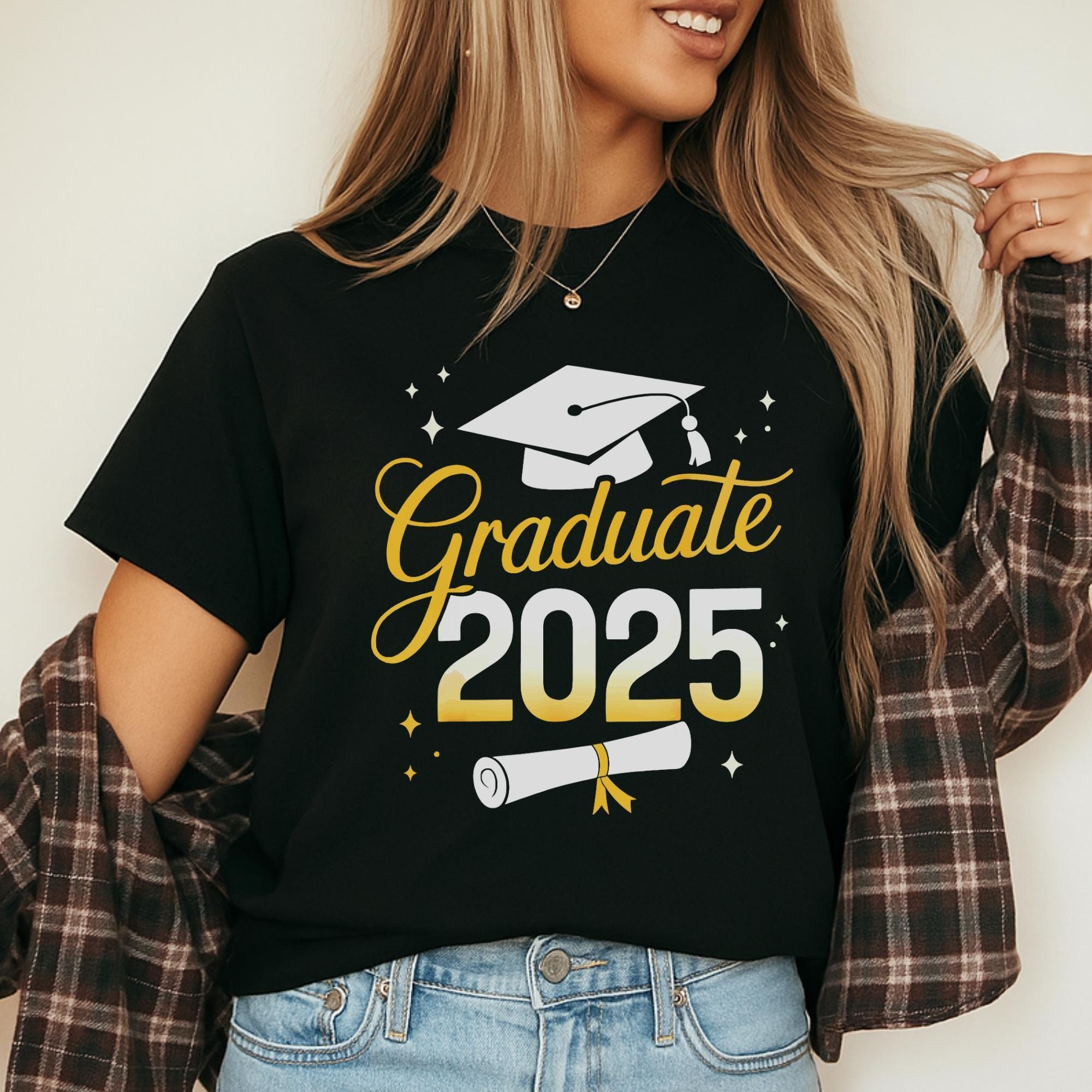 A woman wearing a black t-shirt with a graduation cap and the text "Graduate 2025" printed on it.
