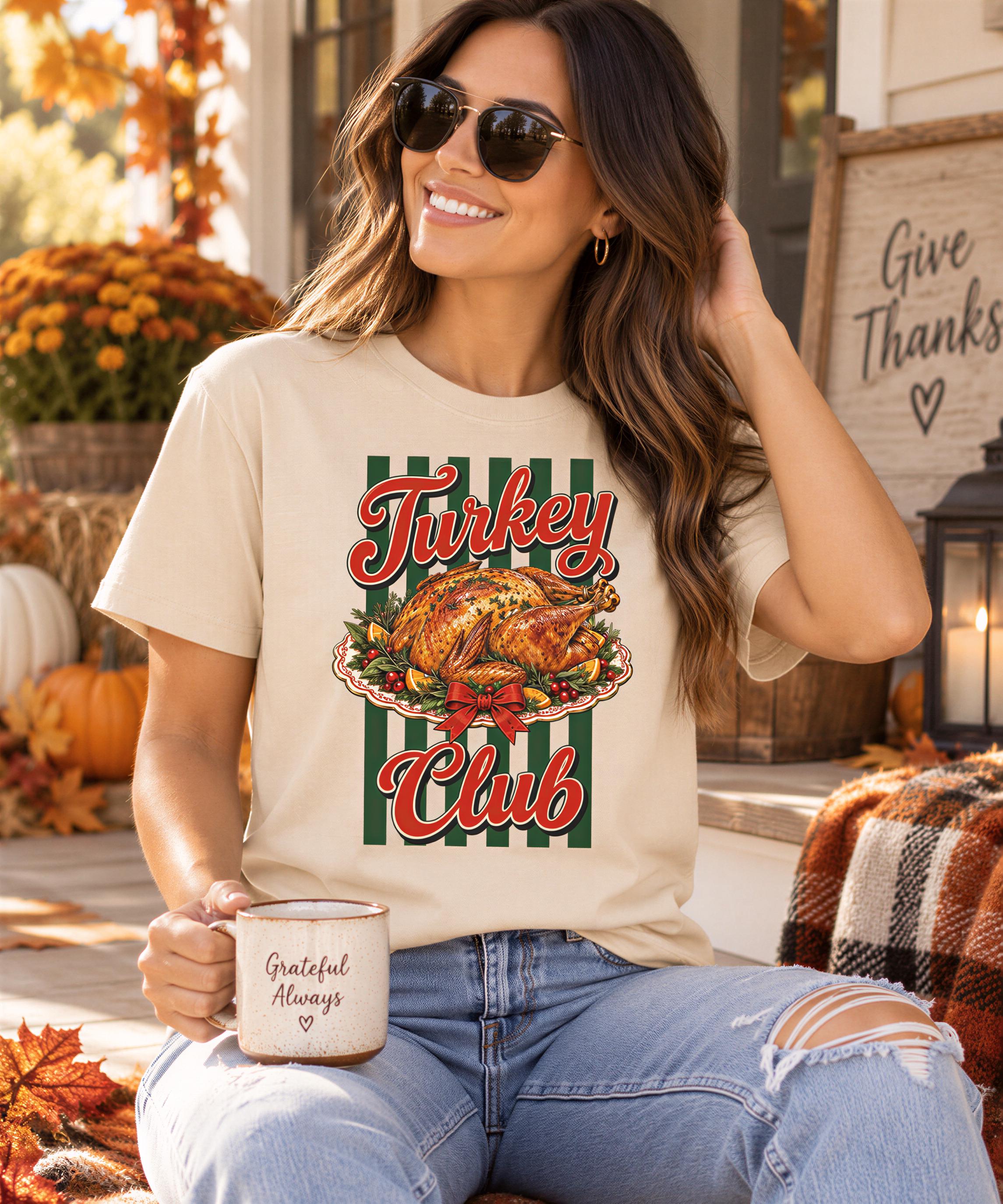 A woman wearing sunglasses and a t-shirt with a turkey graphic is sitting on a porch, holding a coffee mug and smiling.