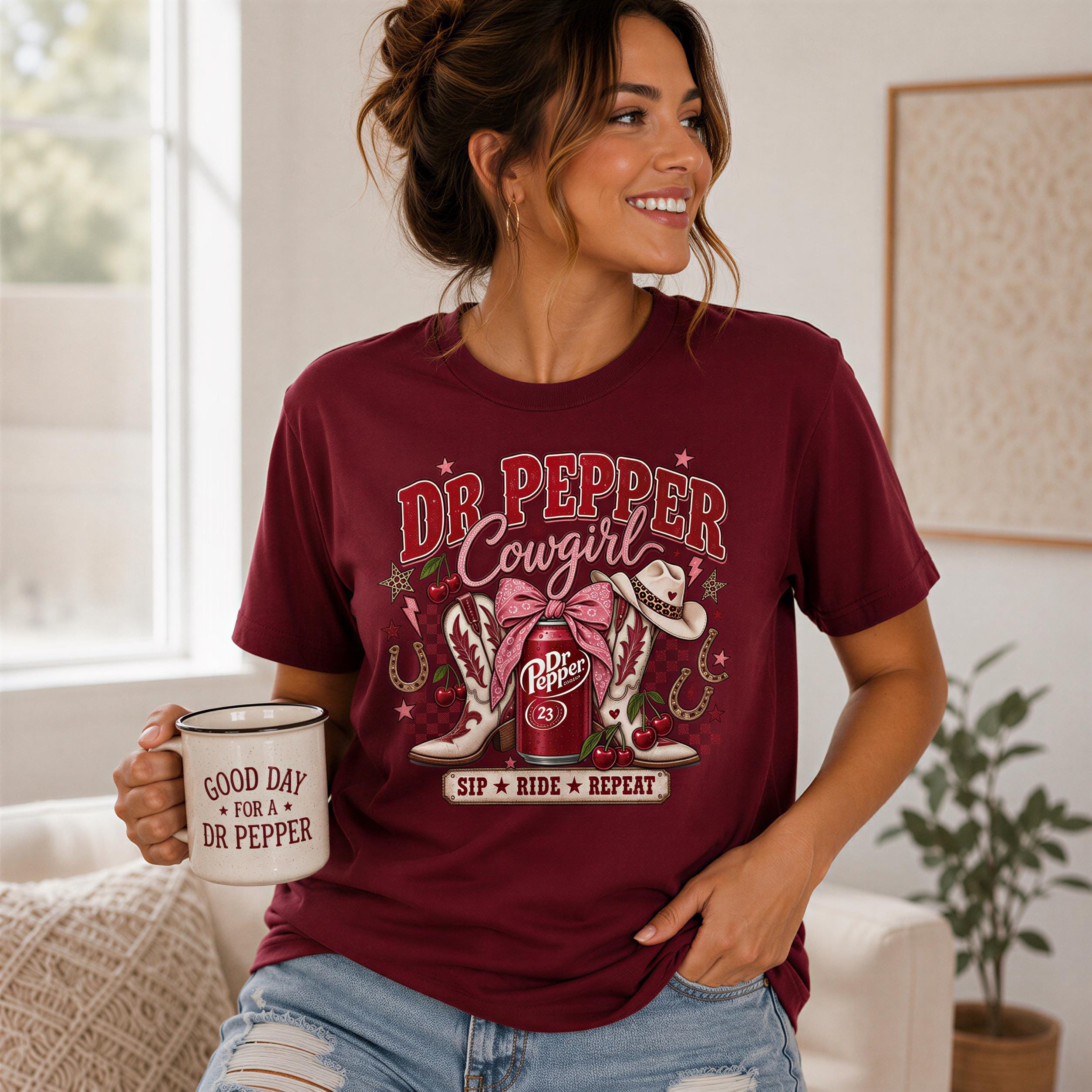 A woman wearing a burgundy t-shirt with a graphic design and holding a mug with the text "Good day for Dr Pepper Cowgirl" printed on it.
