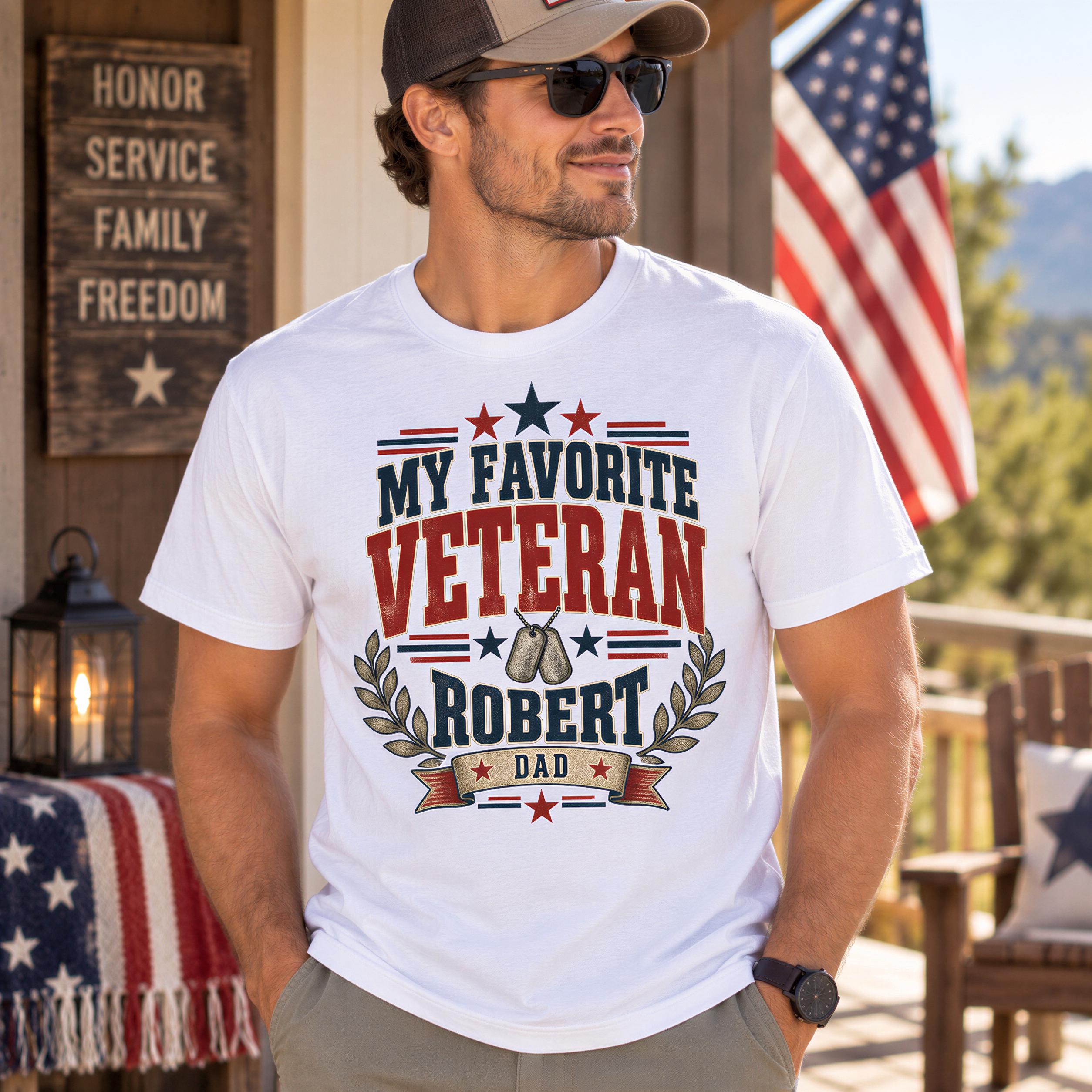 A man wearing a white t-shirt with a patriotic design stands in front of a wooden structure with an American flag.