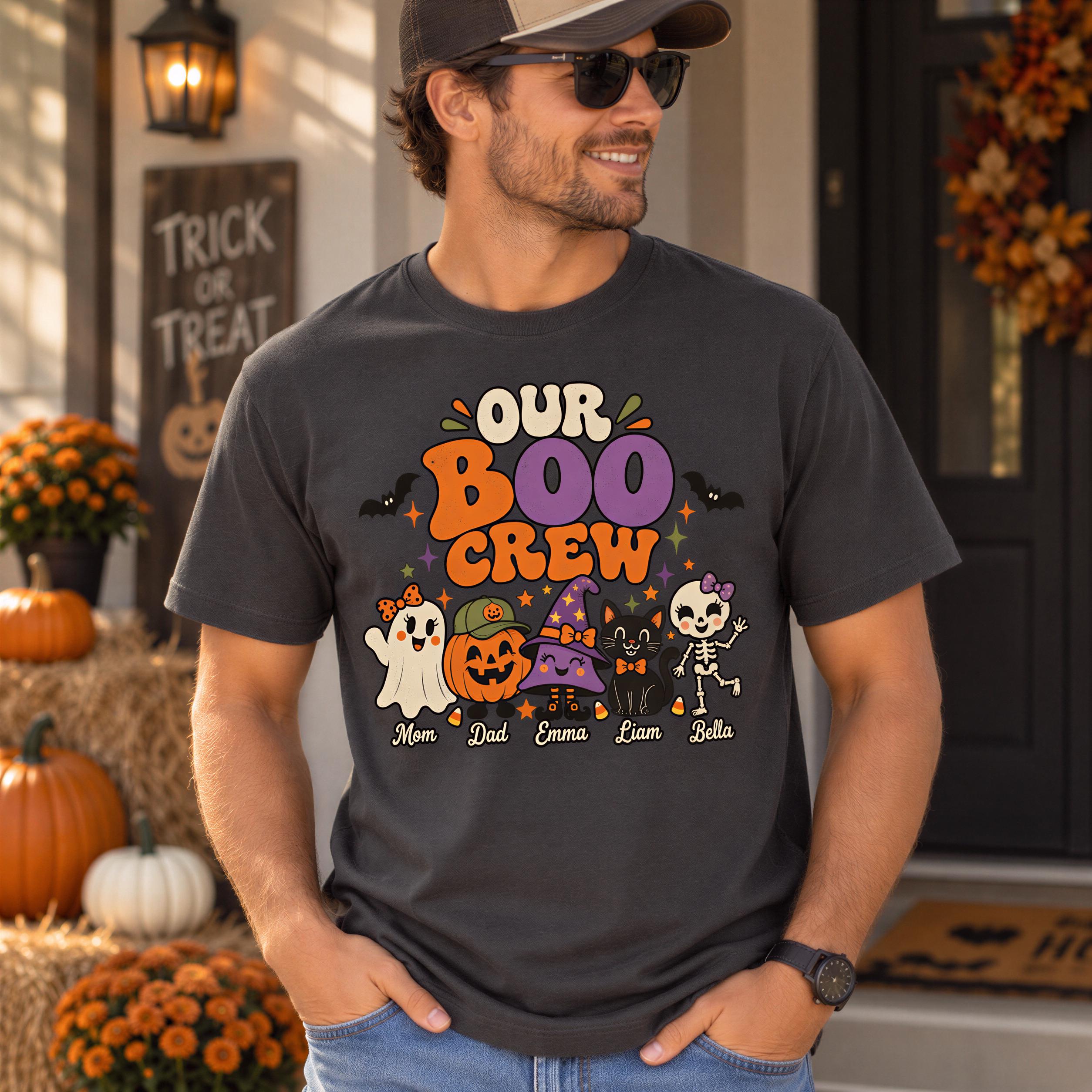 A man wearing a black t-shirt with a Halloween-themed graphic and text, standing in front of a house decorated for Halloween.