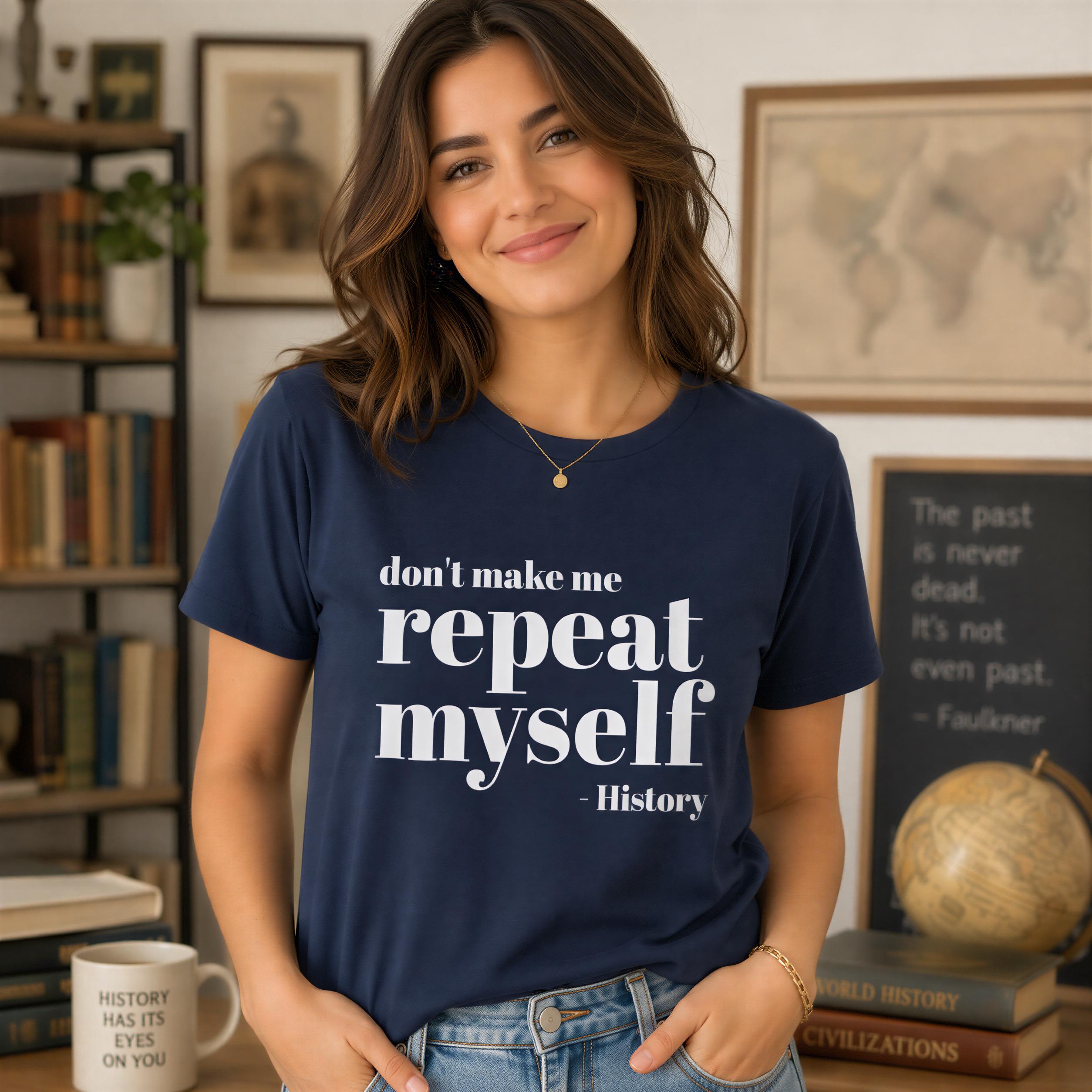 A woman wearing a navy blue t-shirt with the text "don't make me repeat myself - history" stands in front of a bookshelf filled with books.
