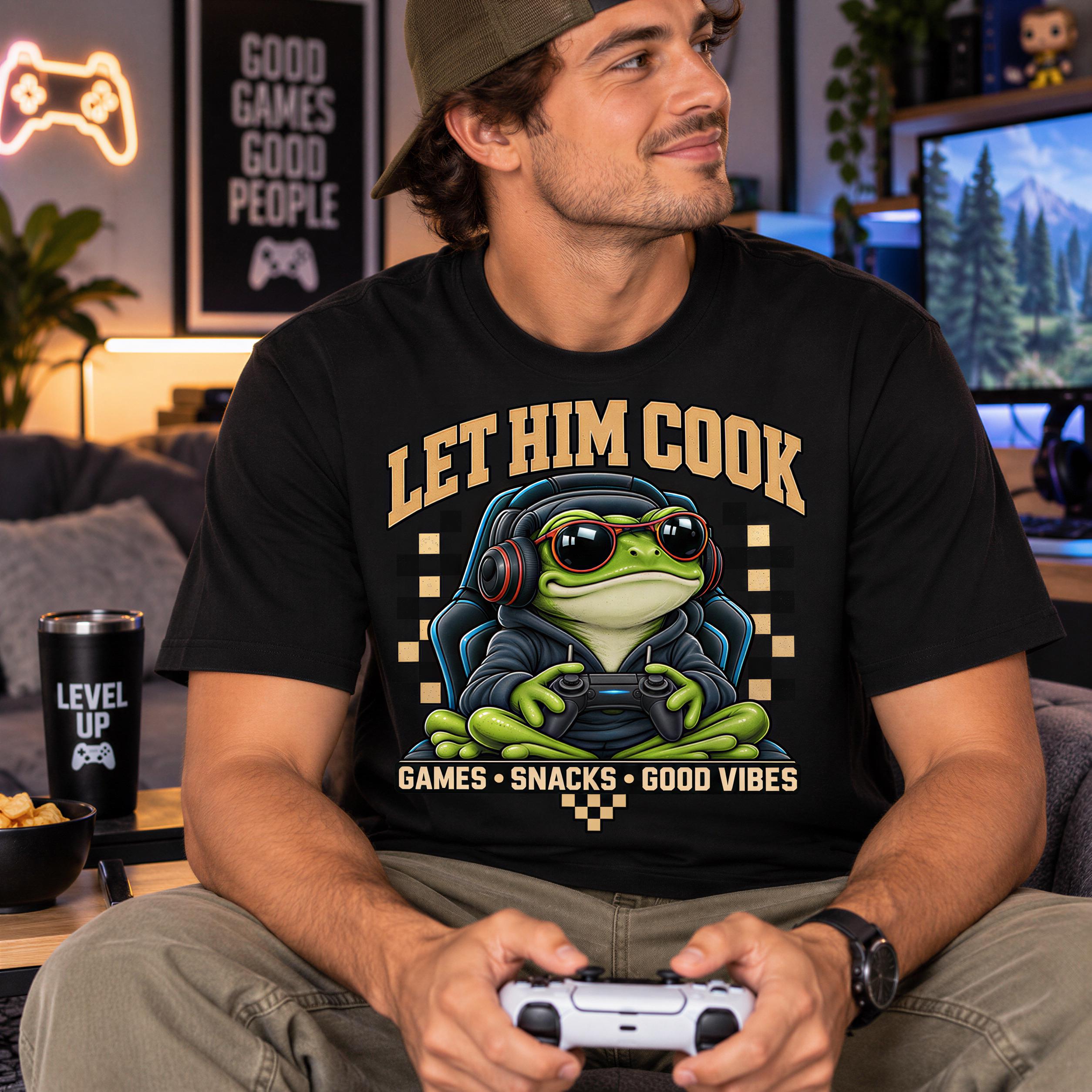 A man wearing a black t-shirt with a cartoon frog and text, sitting on a couch and holding a video game controller.