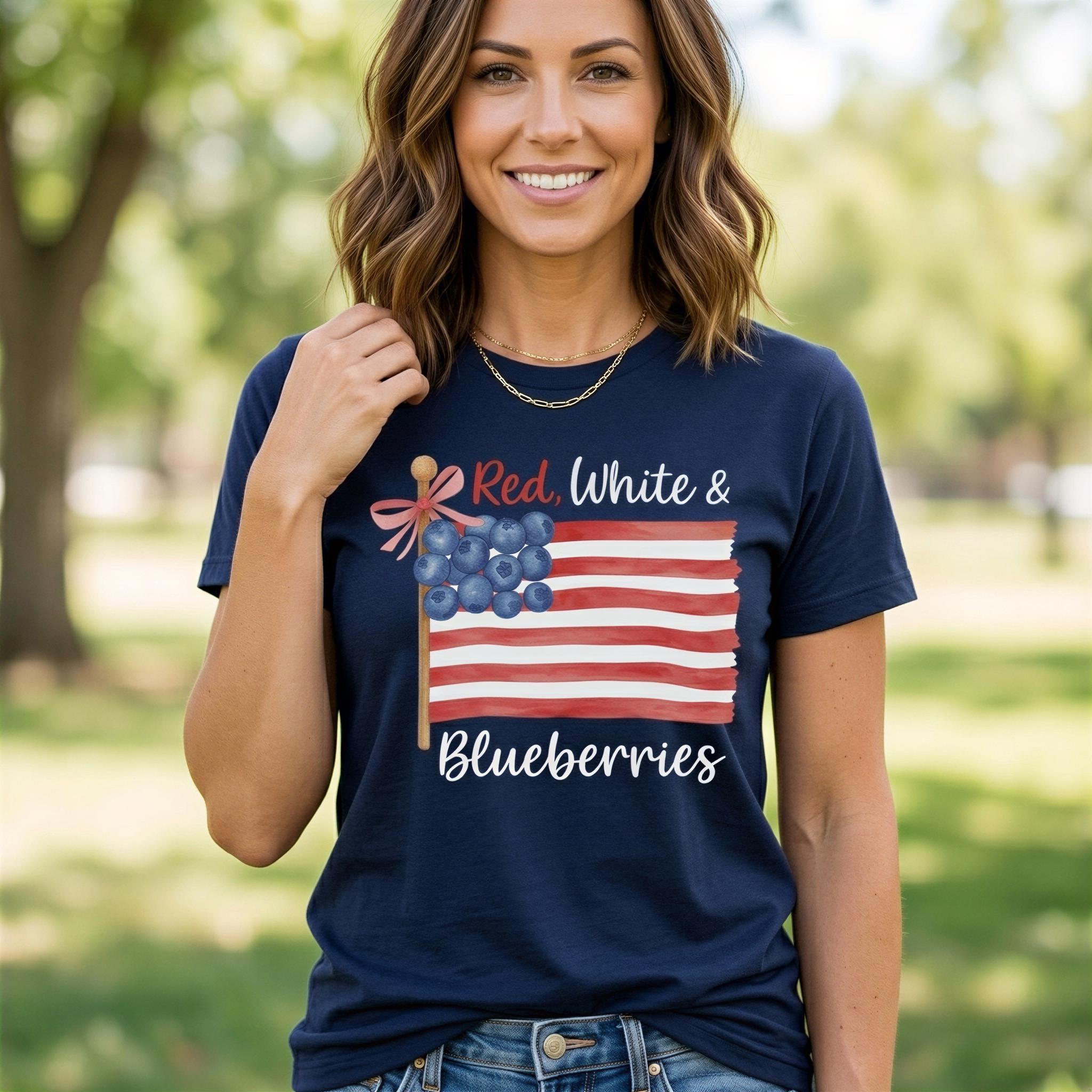 A woman wearing a navy blue t-shirt with an American flag design and the text "Red, White & Blueberries" printed on it, smiling at the camera.