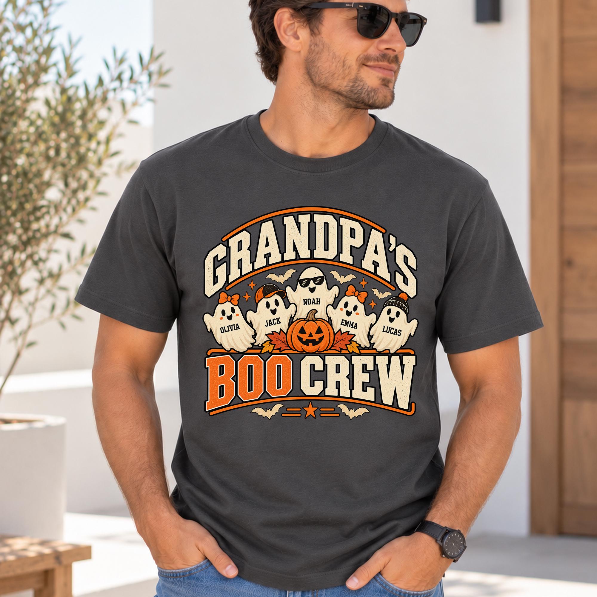A man wearing a t-shirt with a graphic design featuring a group of ghostly figures and a jack-o-lantern, along with the text "GRANDPA'S BOO CREW".