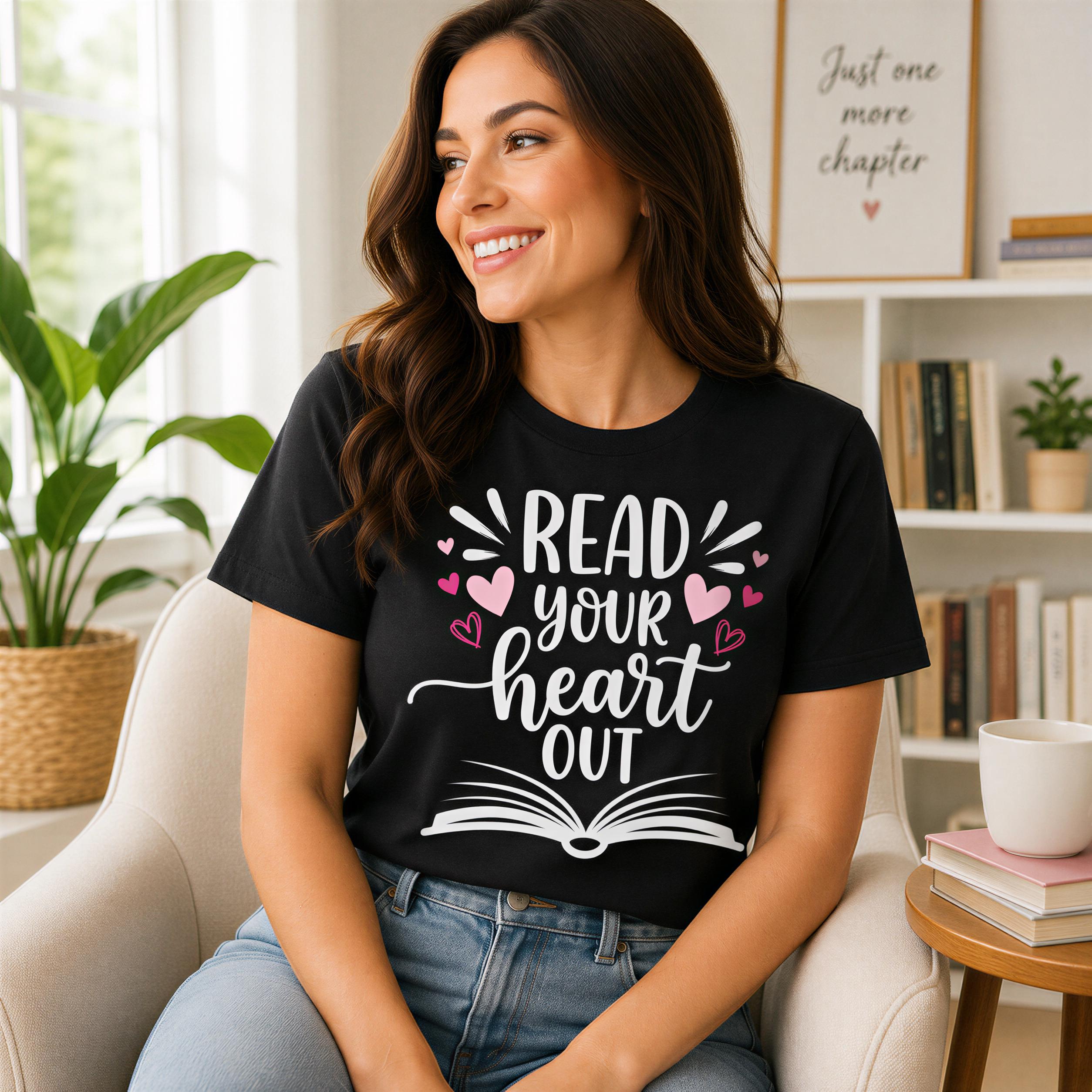 A woman wearing a black t-shirt with the text "Read your heart out" is sitting in a chair in a room with bookshelves and a potted plant.