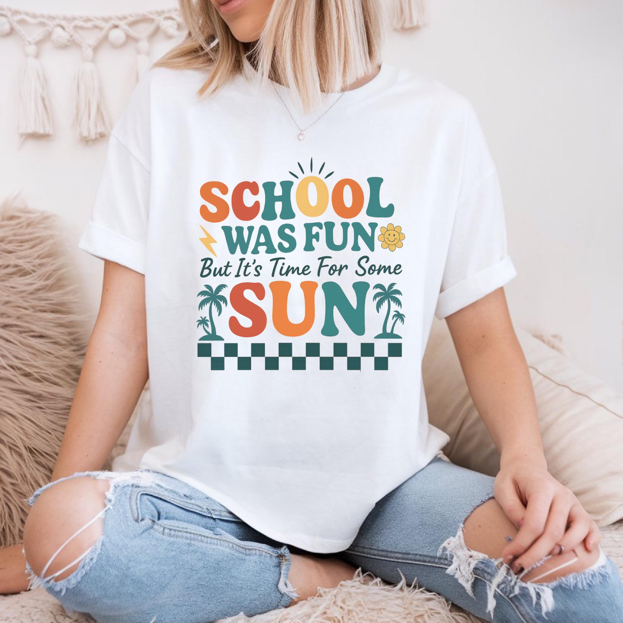 A woman wearing a white t-shirt with a colorful graphic design that says "School was fun but it's time for some sun".