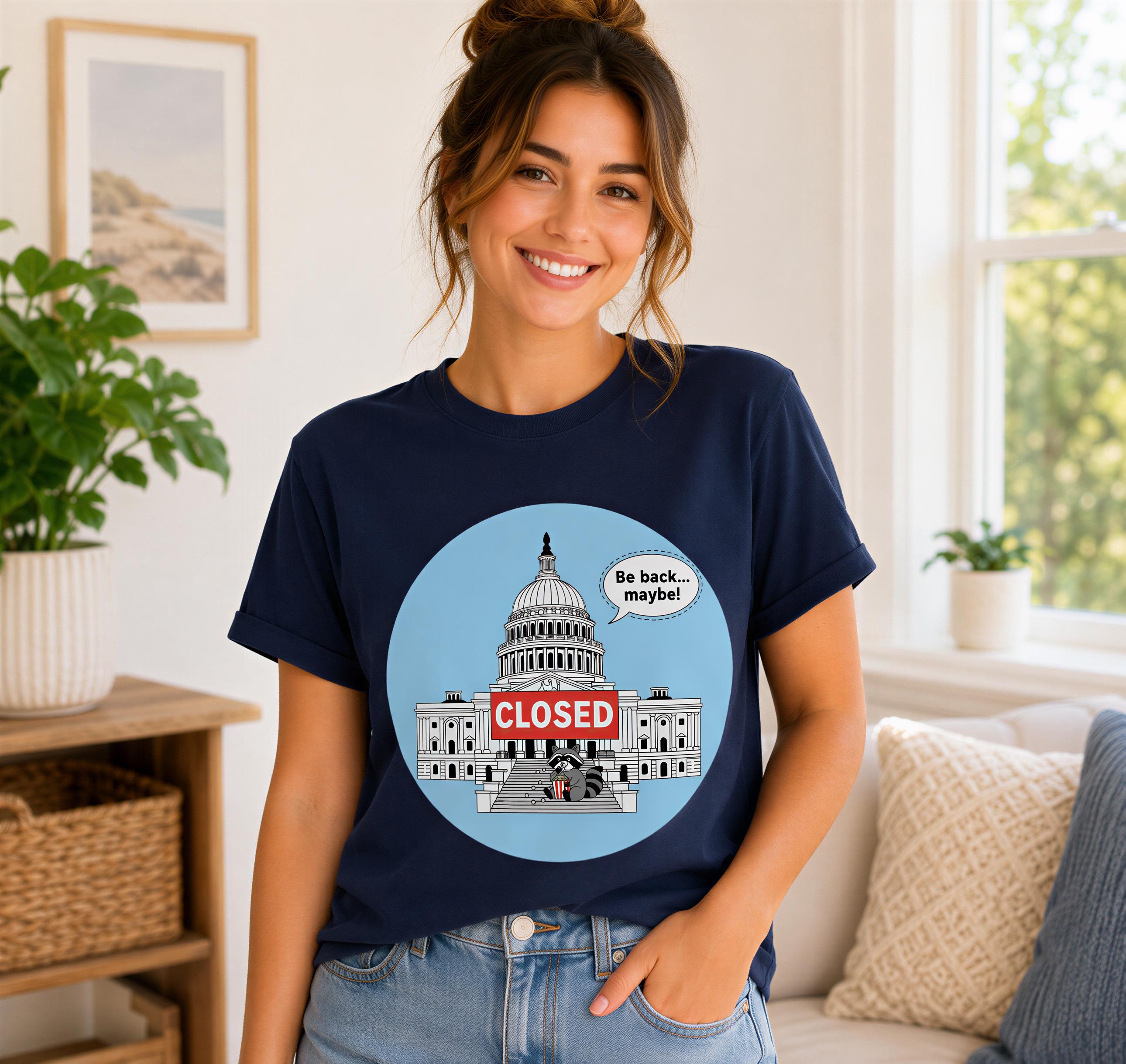 A woman wearing a navy blue t-shirt with a graphic of the United States Capitol building and a speech bubble saying "Be back... maybe!"