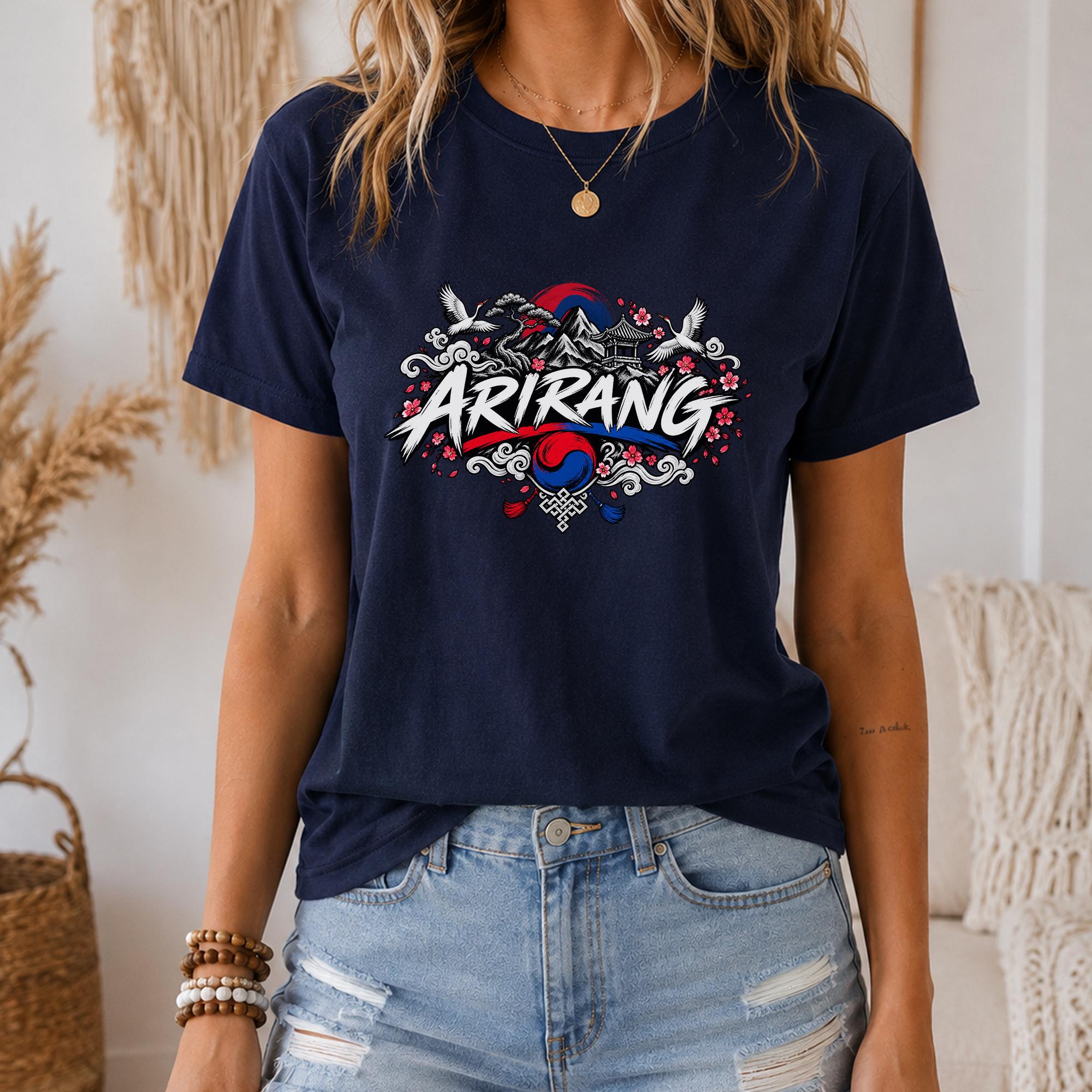 A woman wearing a navy blue t-shirt with a graphic design featuring the word "ARIRANG" and various decorative elements.