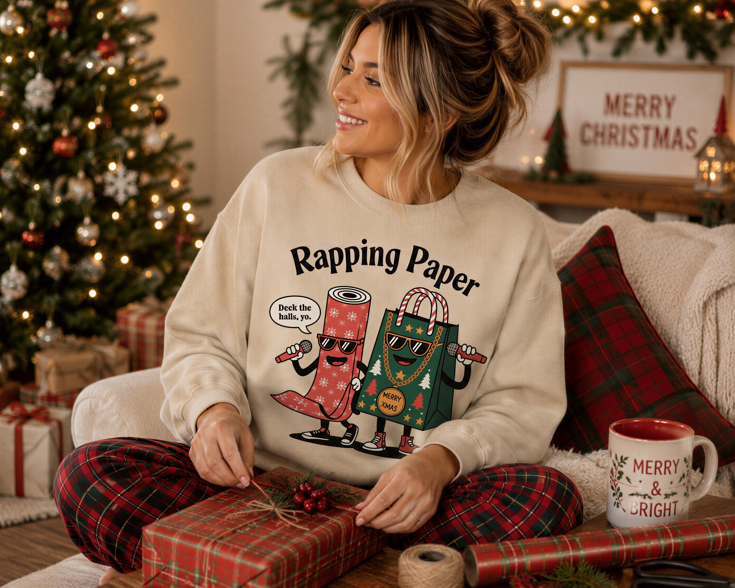 A woman sitting on a couch, smiling and holding a wrapped gift, wearing a sweater with a cartoon character design.