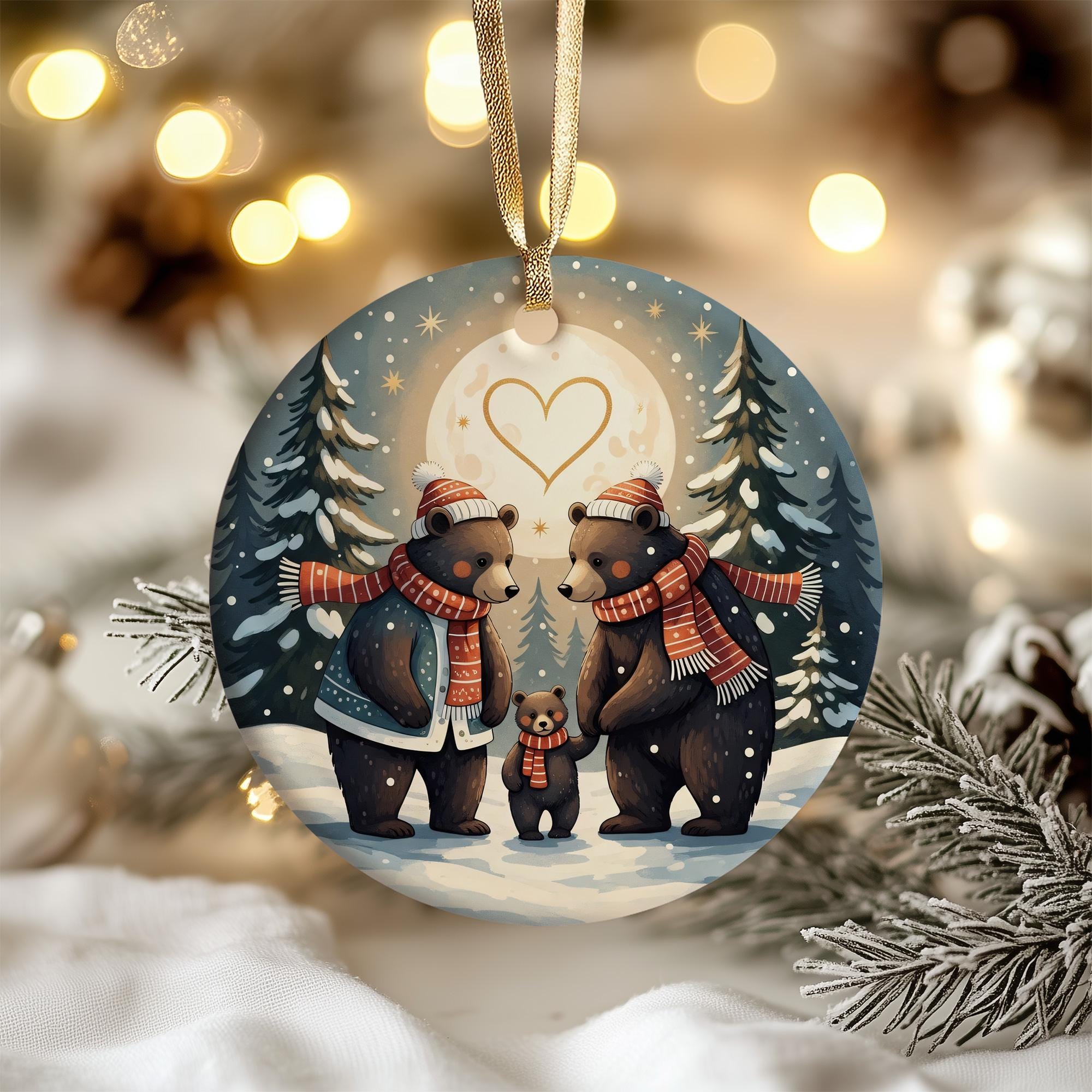 A round ornament featuring a family of bears in a snowy winter scene, with a heart symbol in the center.