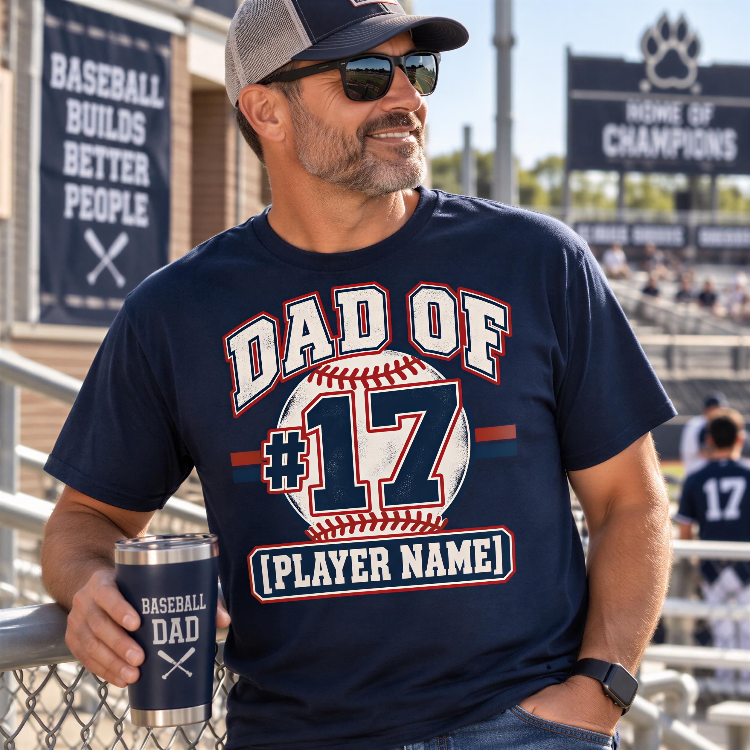 A man wearing a baseball-themed t-shirt and holding a baseball mug stands in front of a baseball stadium.