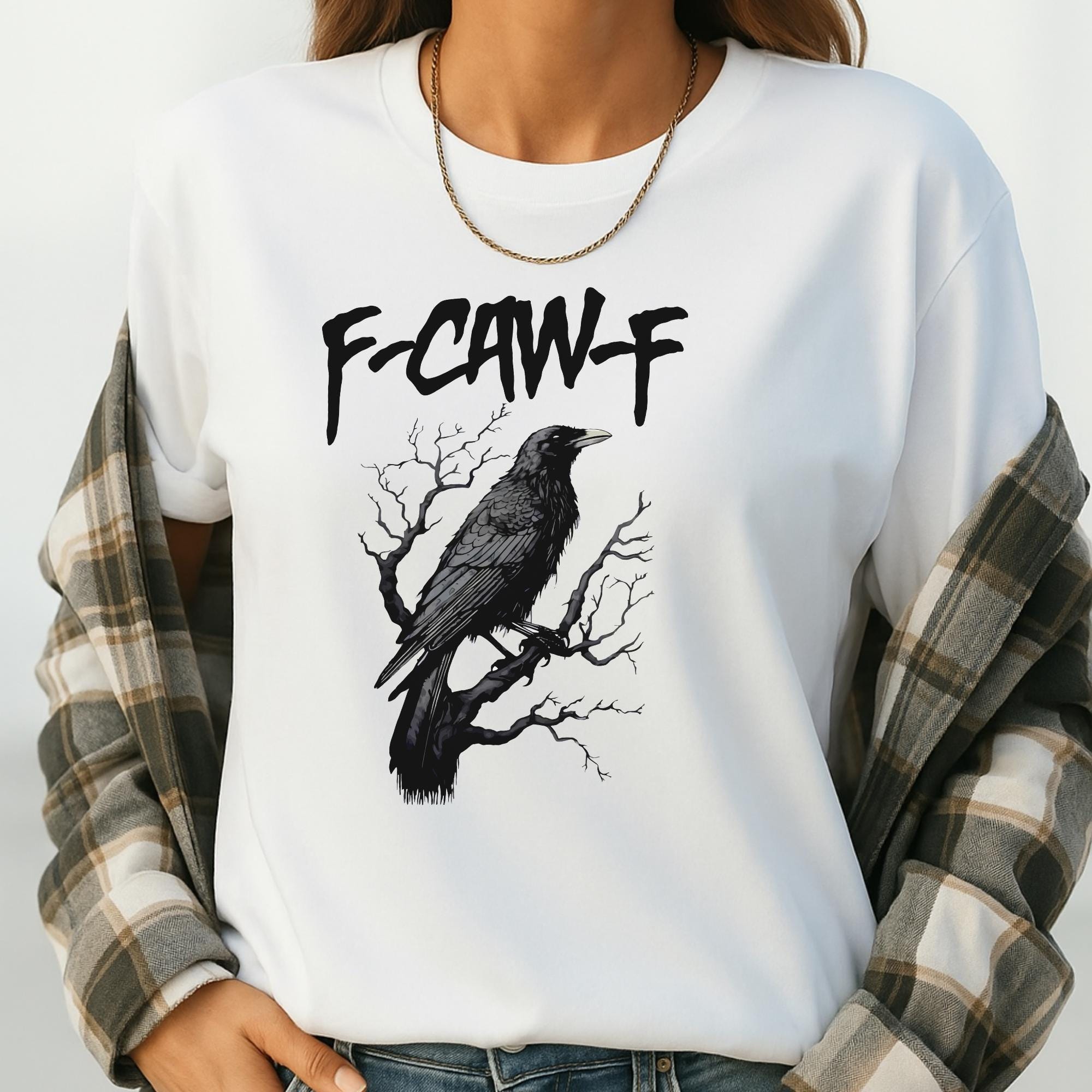 A white t-shirt with a black graphic design depicting a bird perched on a tree branch.