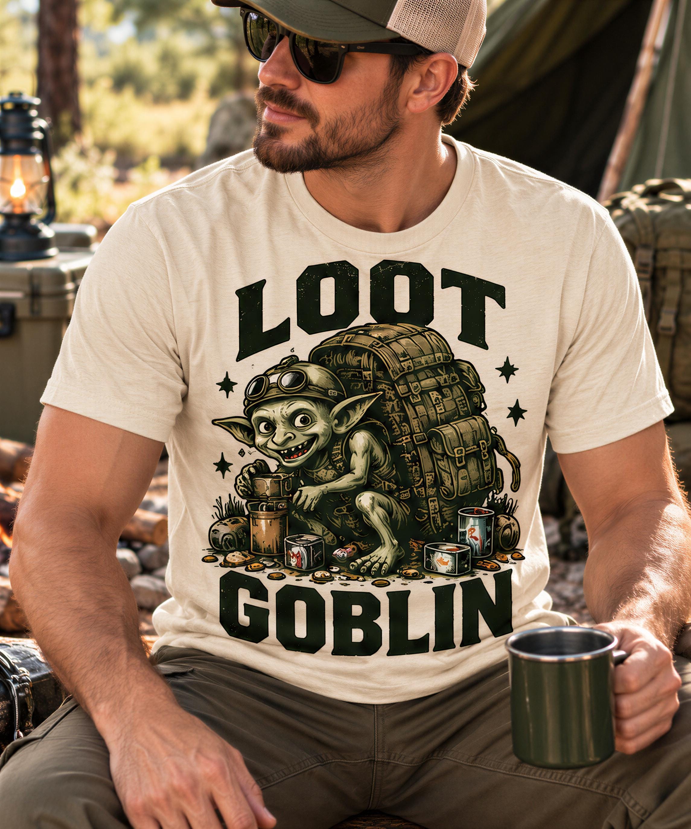 A man wearing a t-shirt with a graphic of a gnome-like character and the text "LOT GOBLIN" is sitting outdoors, holding a mug.