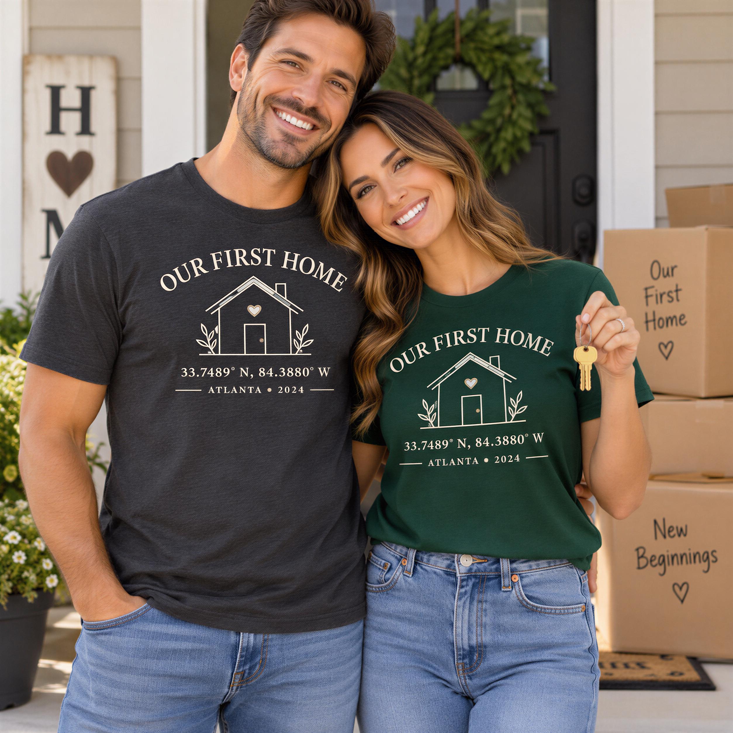 A man and a woman standing in front of a house, both wearing matching t-shirts with the text "Our First Home" and the location "33.749° N, 84.3800 W, Atlanta, Georgia 2024".