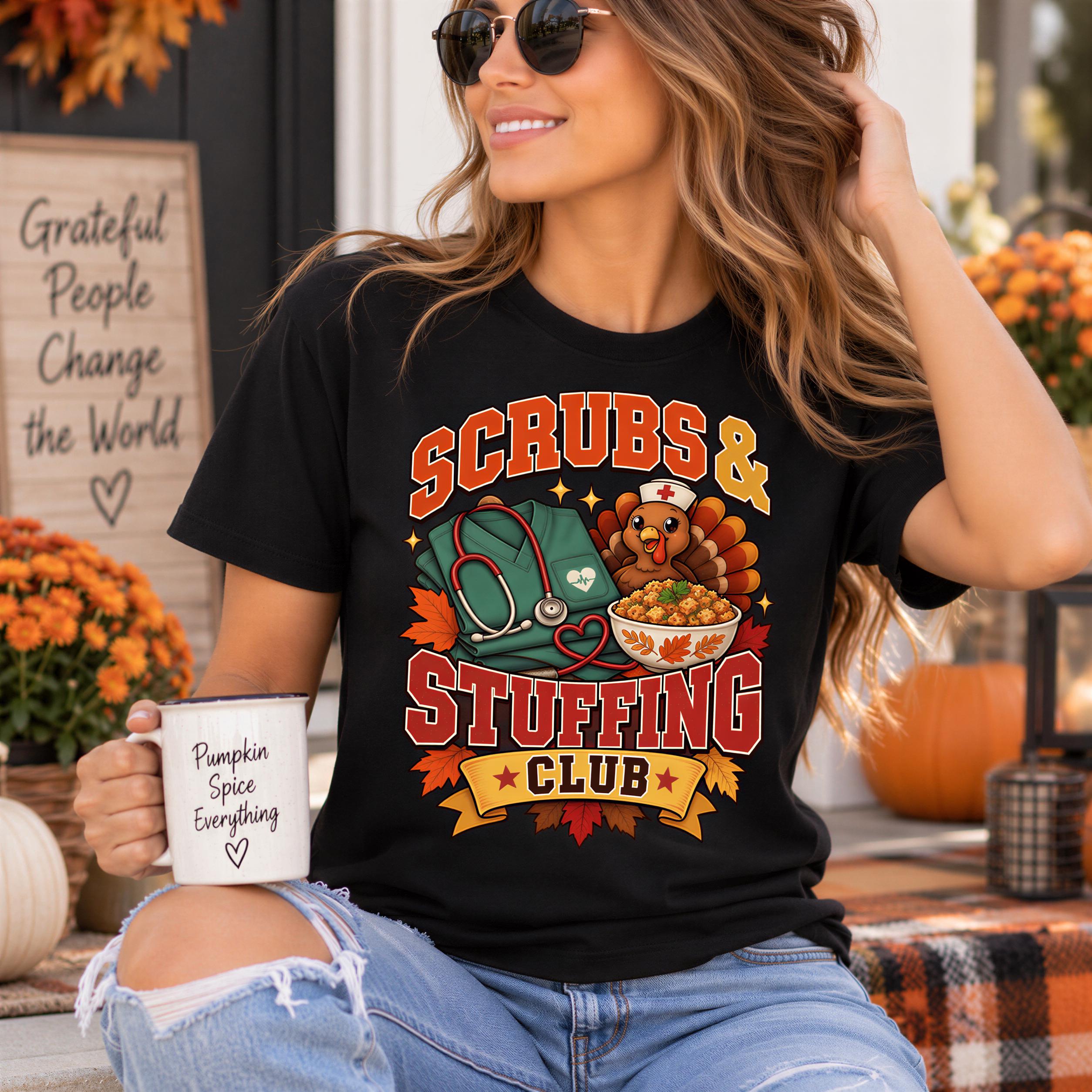 A woman wearing a black t-shirt with a graphic design and holding a pumpkin spice coffee mug, smiling and sitting outdoors with fall decorations in the background.