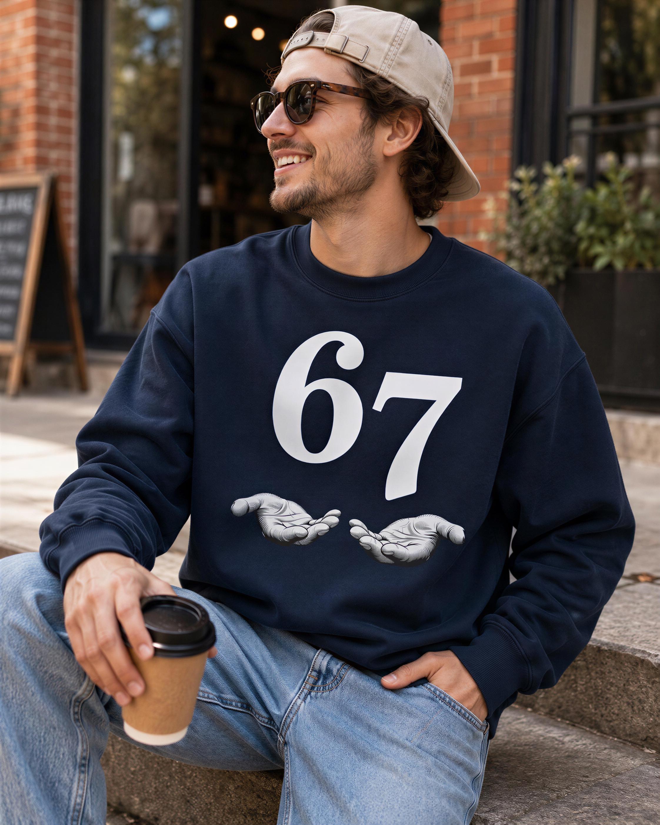 A man wearing a navy blue sweatshirt with the number 67 and a baseball cap is sitting on a step, holding a coffee cup and smiling.