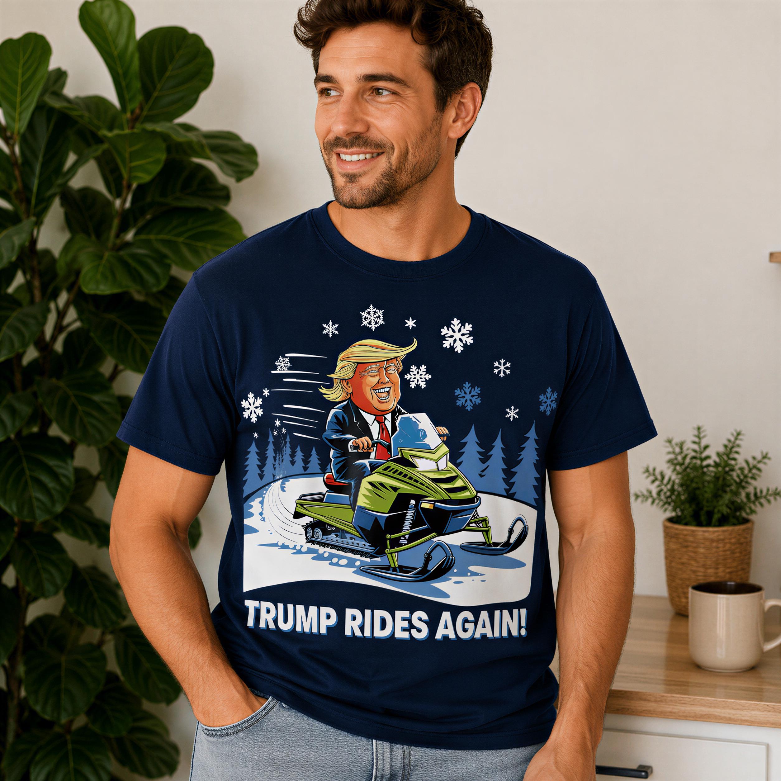 A man wearing a navy blue t-shirt with a cartoon image of a man riding a snowmobile and the text "Trump Rides Again!" printed on it.