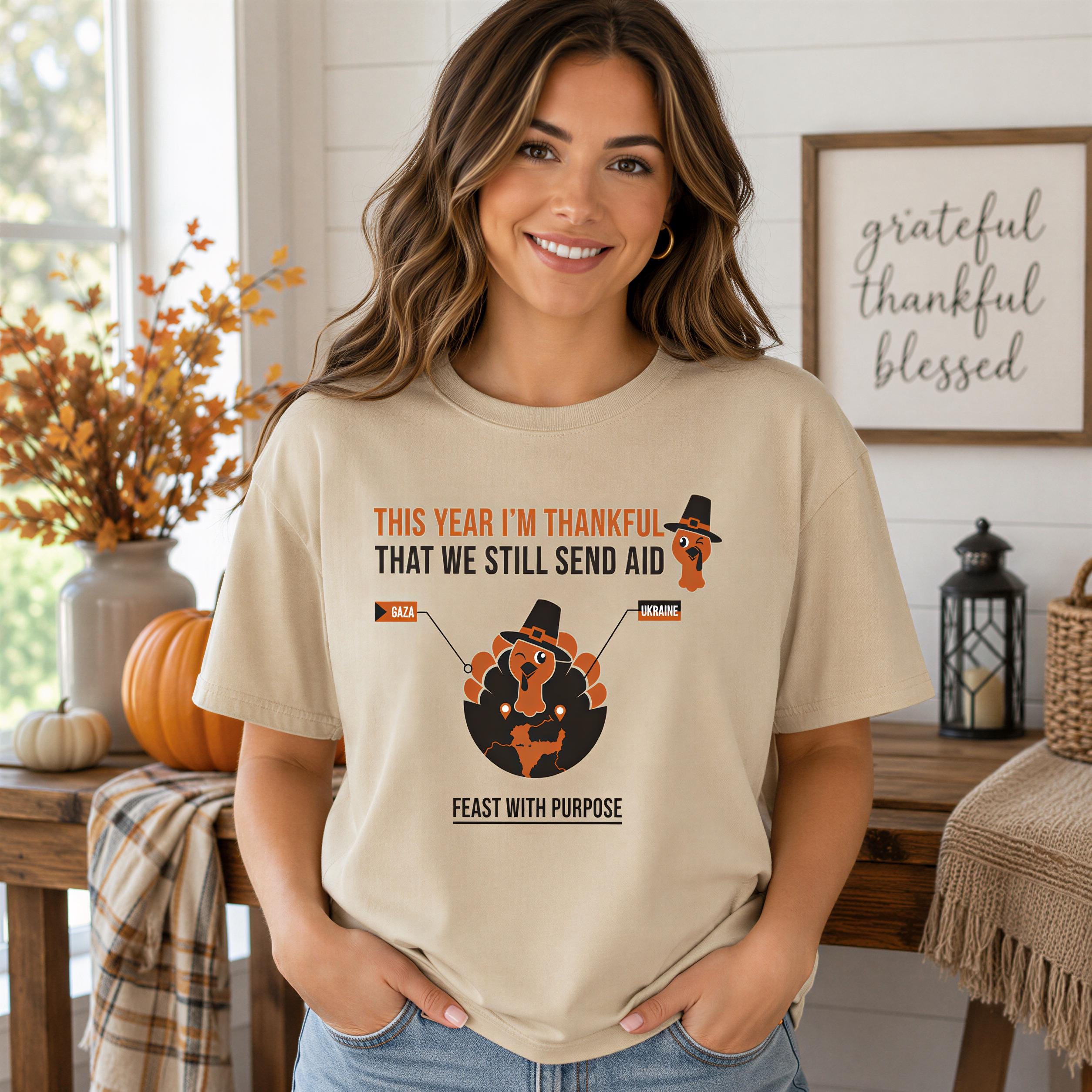 A woman wearing a t-shirt with a humorous Thanksgiving-themed graphic and text, smiling at the camera.