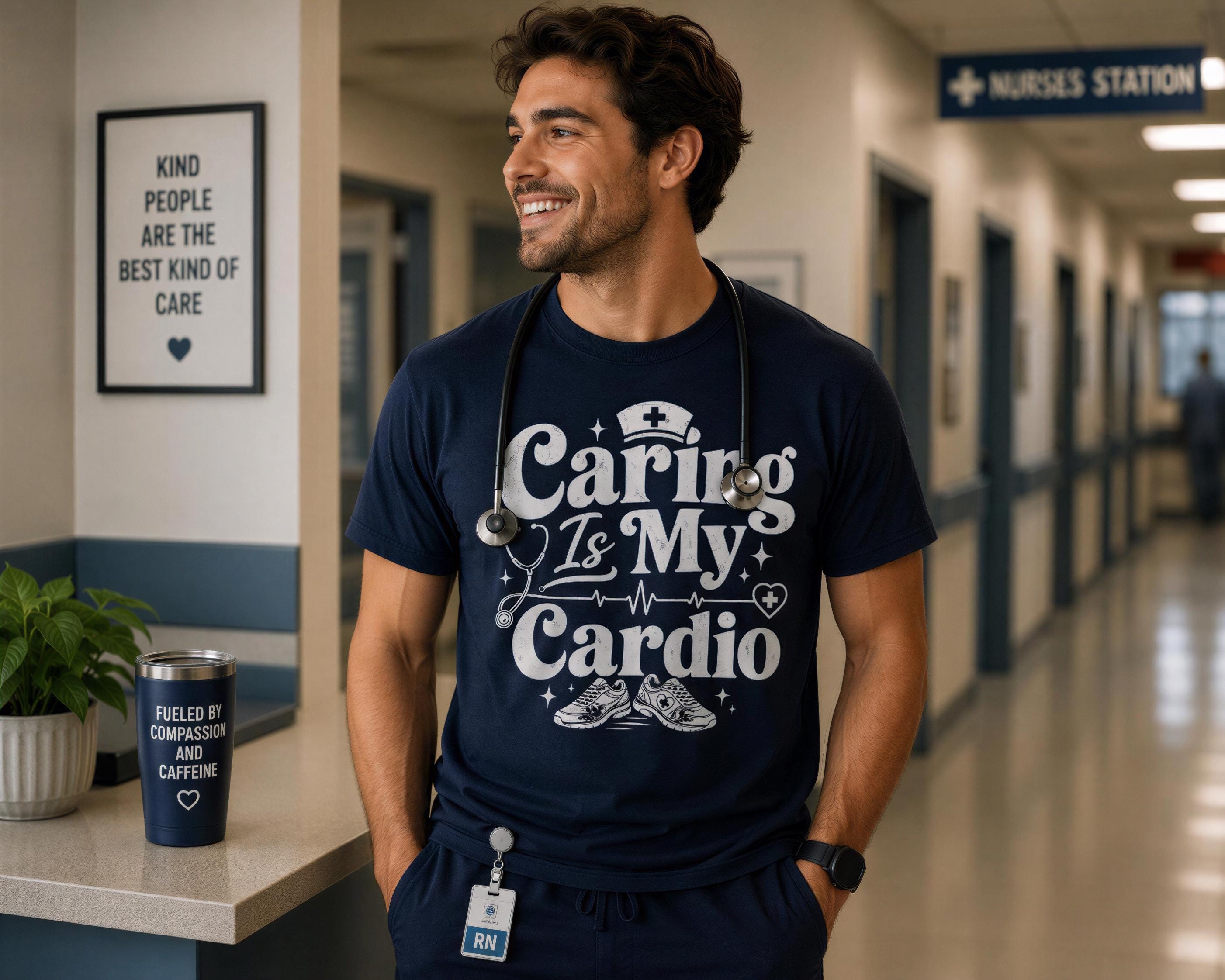 A smiling man wearing a blue t-shirt with a white design stands in a hallway, with a framed sign above him that says "KIND PEOPLE ARE THE BEST KIND OF CARE" and a cup with a message that reads "FUELLED BY ASSISTANCE, I CRETE".