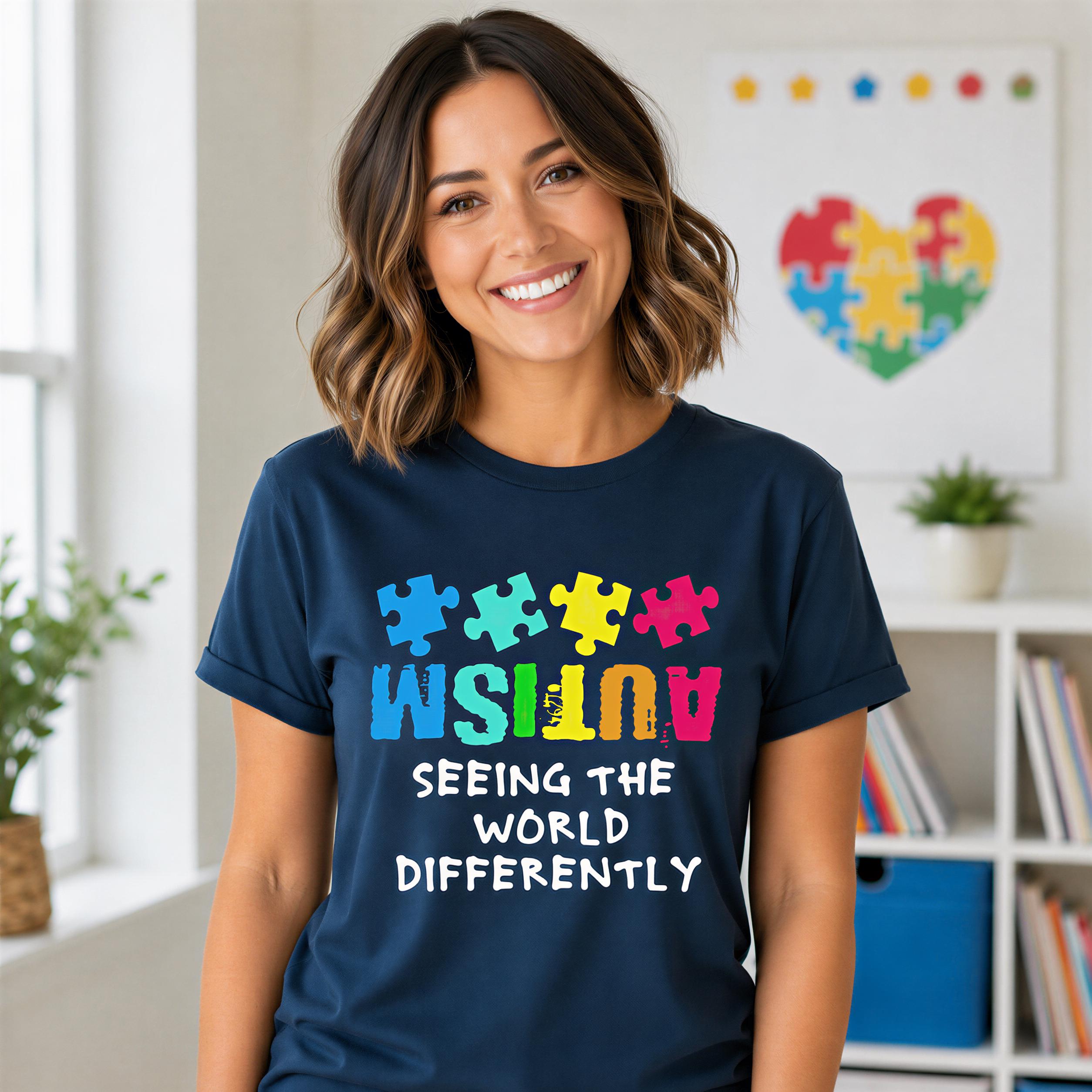 A woman wearing a navy blue t-shirt with a colorful graphic design and text, smiling at the camera.