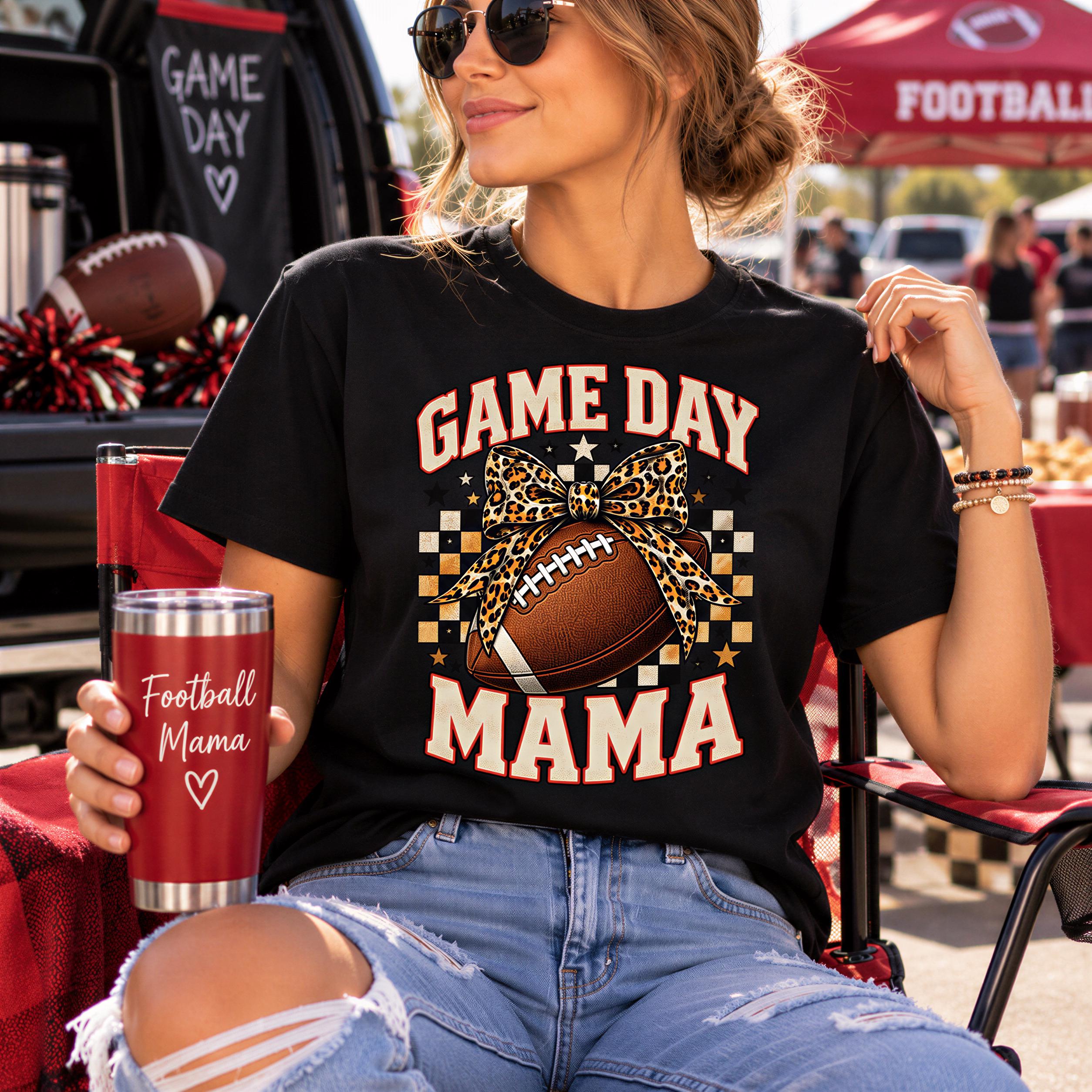 A woman wearing a black t-shirt with a football graphic and the text "GAME DAY MAMA" is sitting outdoors, holding a red tumbler with the text "Football Mama" printed on it.