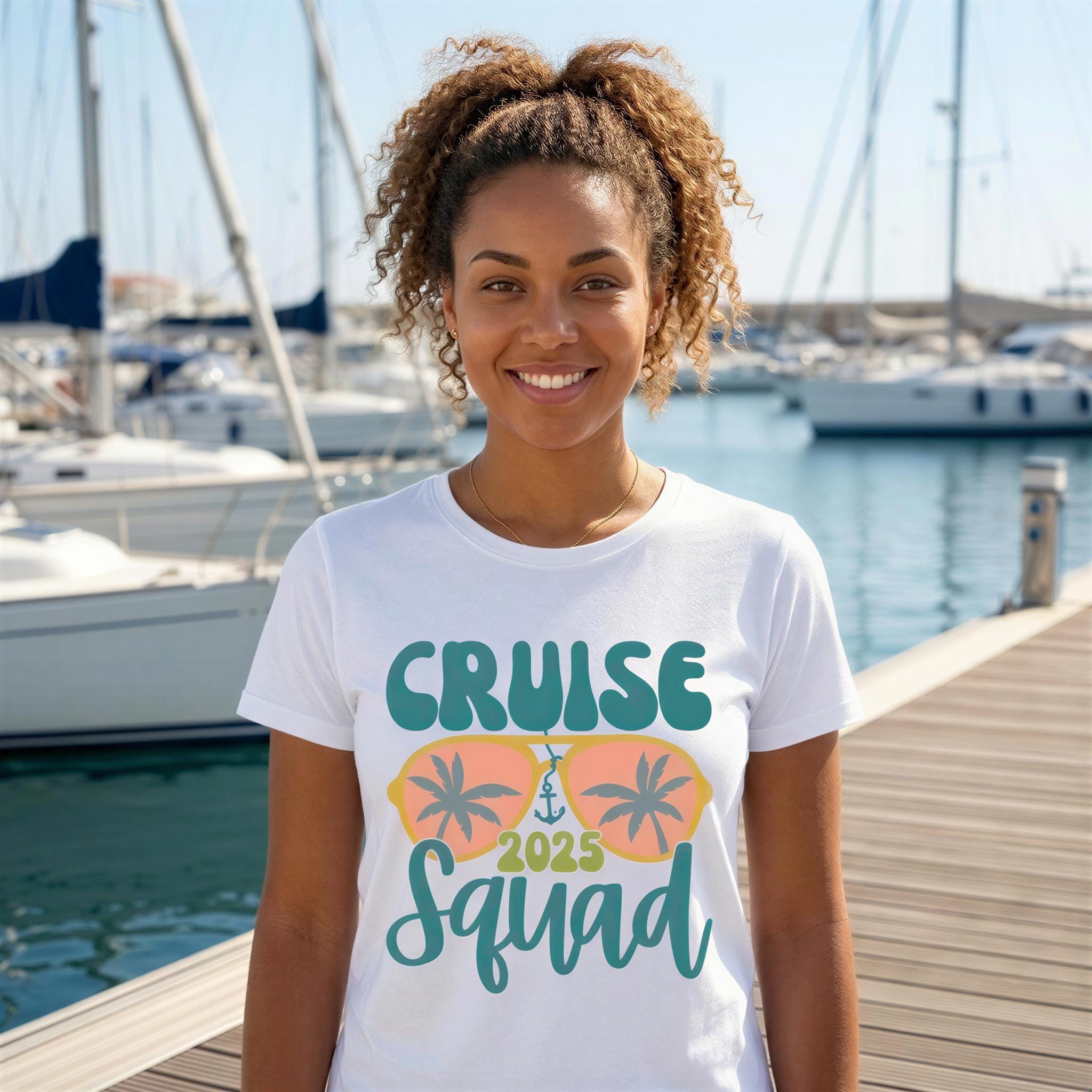 A smiling woman wearing a white t-shirt with a graphic design of a cruise ship and the text "Cruise Squad" stands in front of a marina with sailboats.