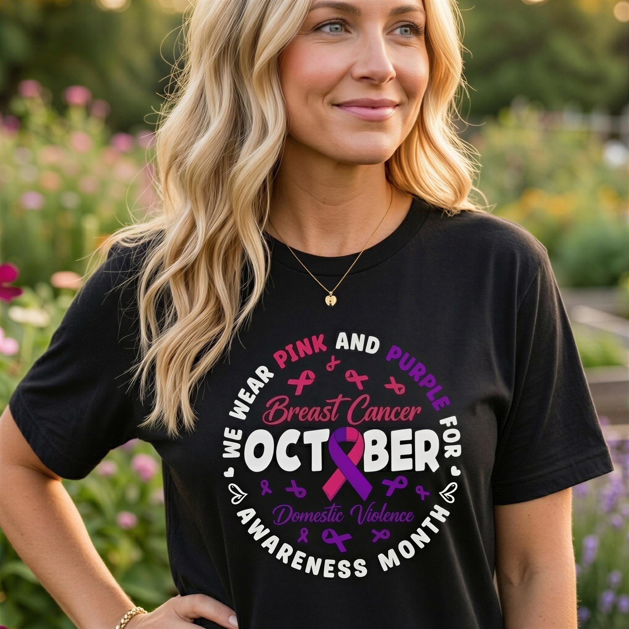A woman wearing a black t-shirt with a pink and purple design that says "We Wear Pink and Purple for Breast Cancer October Awareness Month" and includes a pink ribbon symbol.
