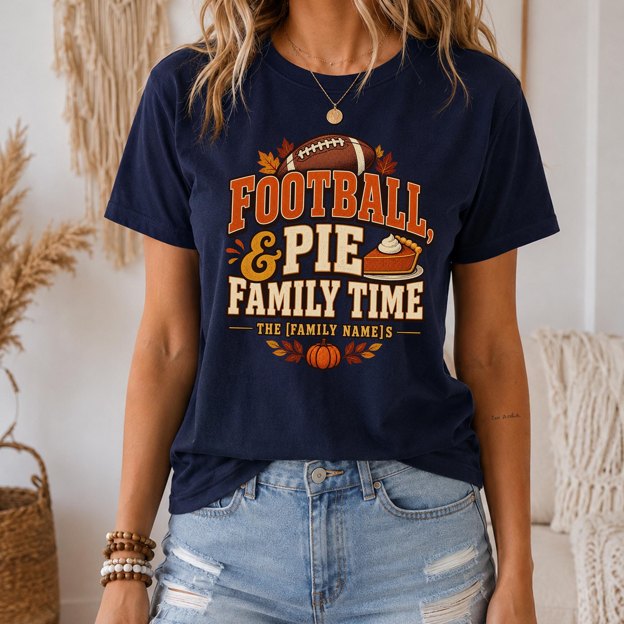 A woman wearing a navy blue t-shirt with a graphic design that says "FOOTBALL & PIE FAMILY TIME" and includes a football, pie, and autumn leaves.