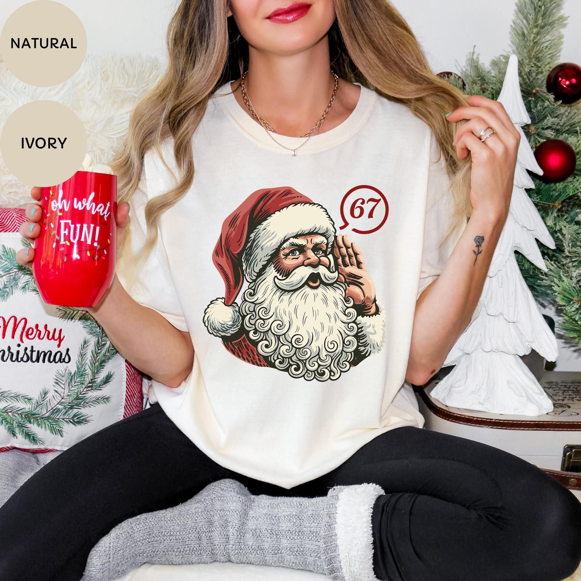A woman wearing a white t-shirt with a Santa Claus graphic and holding a red mug with the text "oh what fun! RUN!"