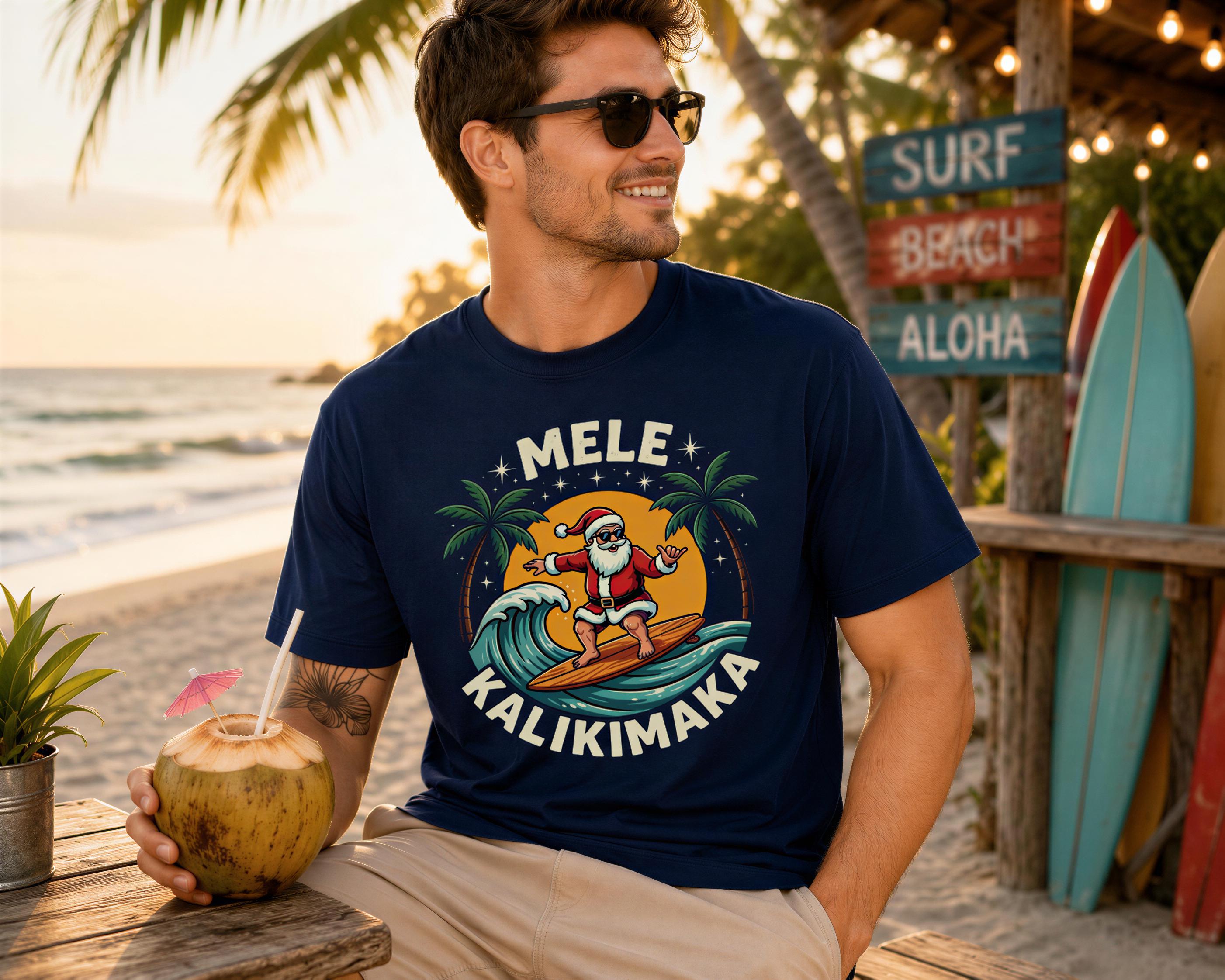 A man wearing a blue t-shirt with a graphic of Santa Claus surfing on a wave, holding a coconut drink, and smiling at the camera.