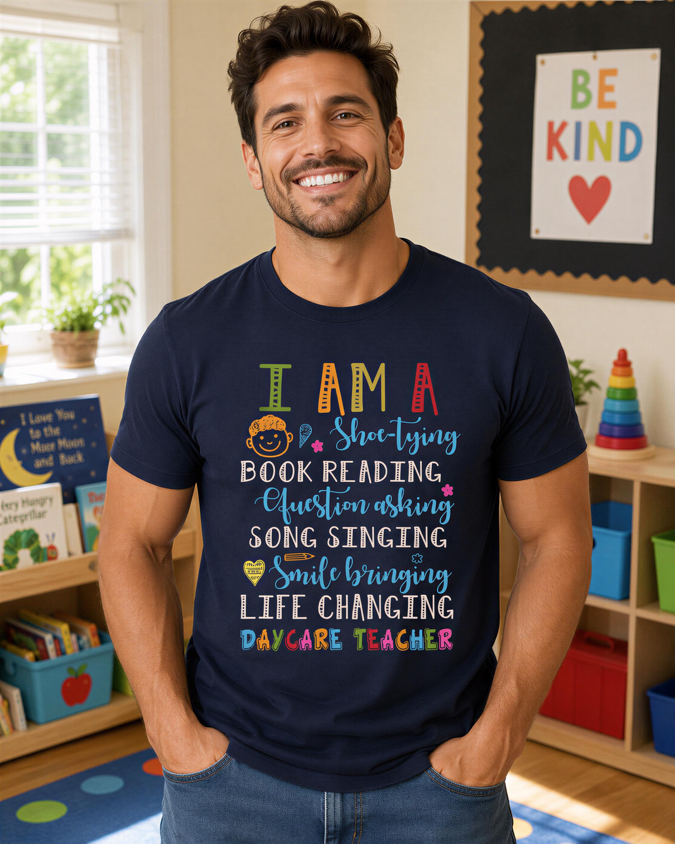 A man wearing a blue t-shirt with text printed on it, standing in a room with a bookshelf and a poster on the wall.