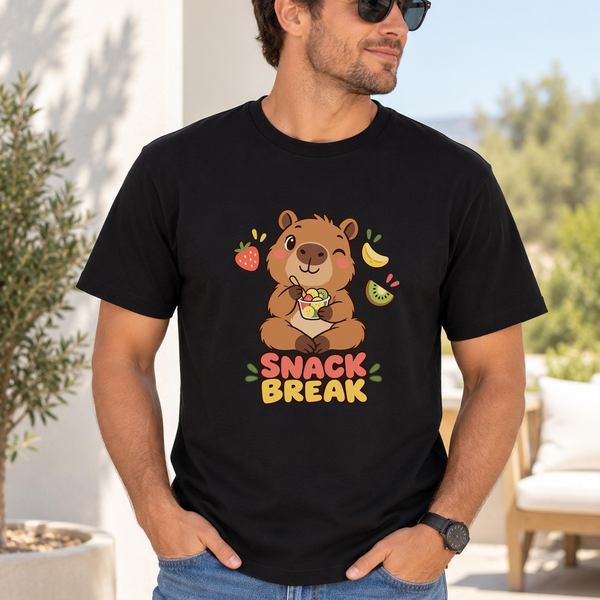A man wearing a black t-shirt with a cartoon image of a bear and the text "SNAACK BREAK" printed on it.
