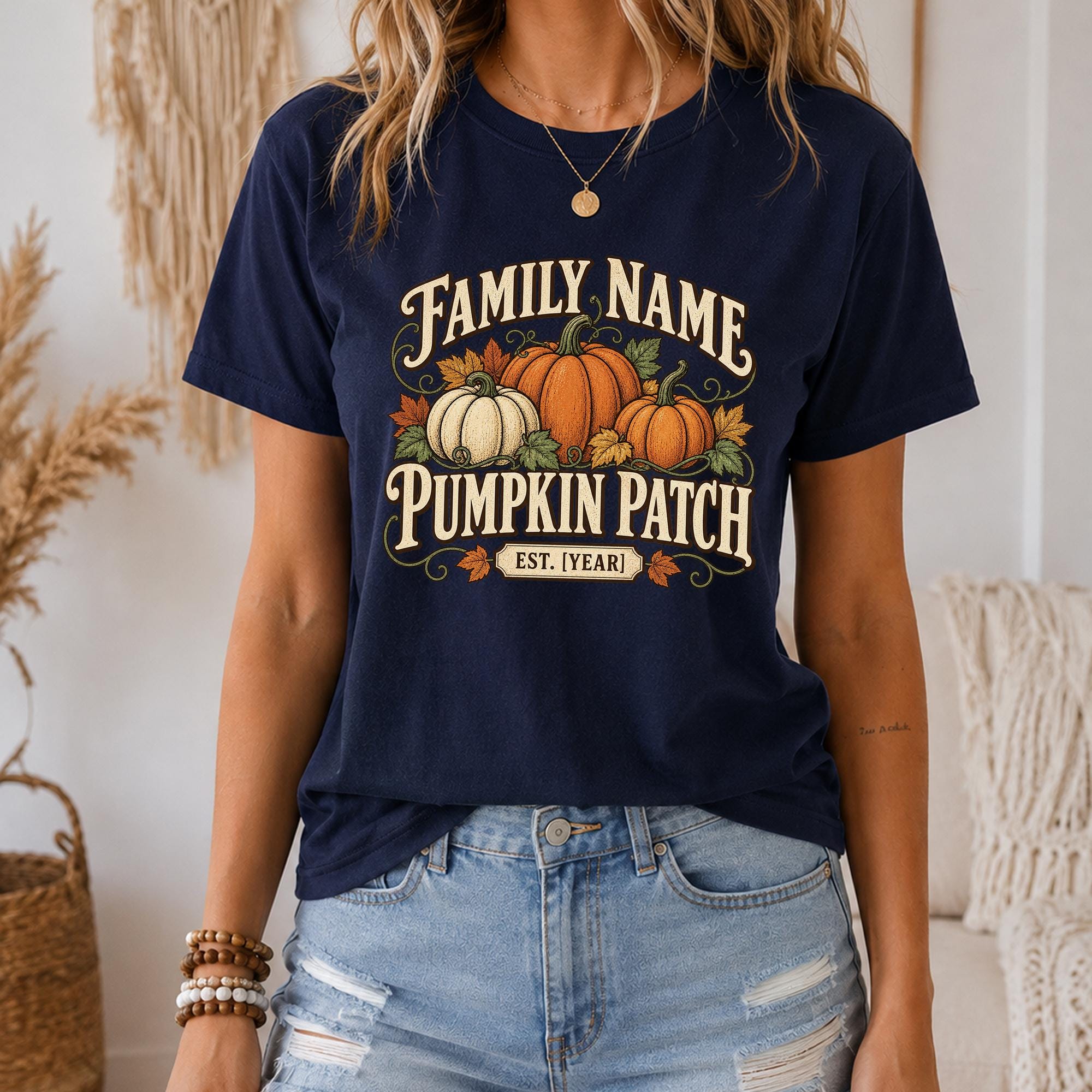 A woman wearing a navy blue t-shirt with a graphic design of pumpkins and the text "Family Name Pumpkin Patch Est. 1 Year" printed on it.