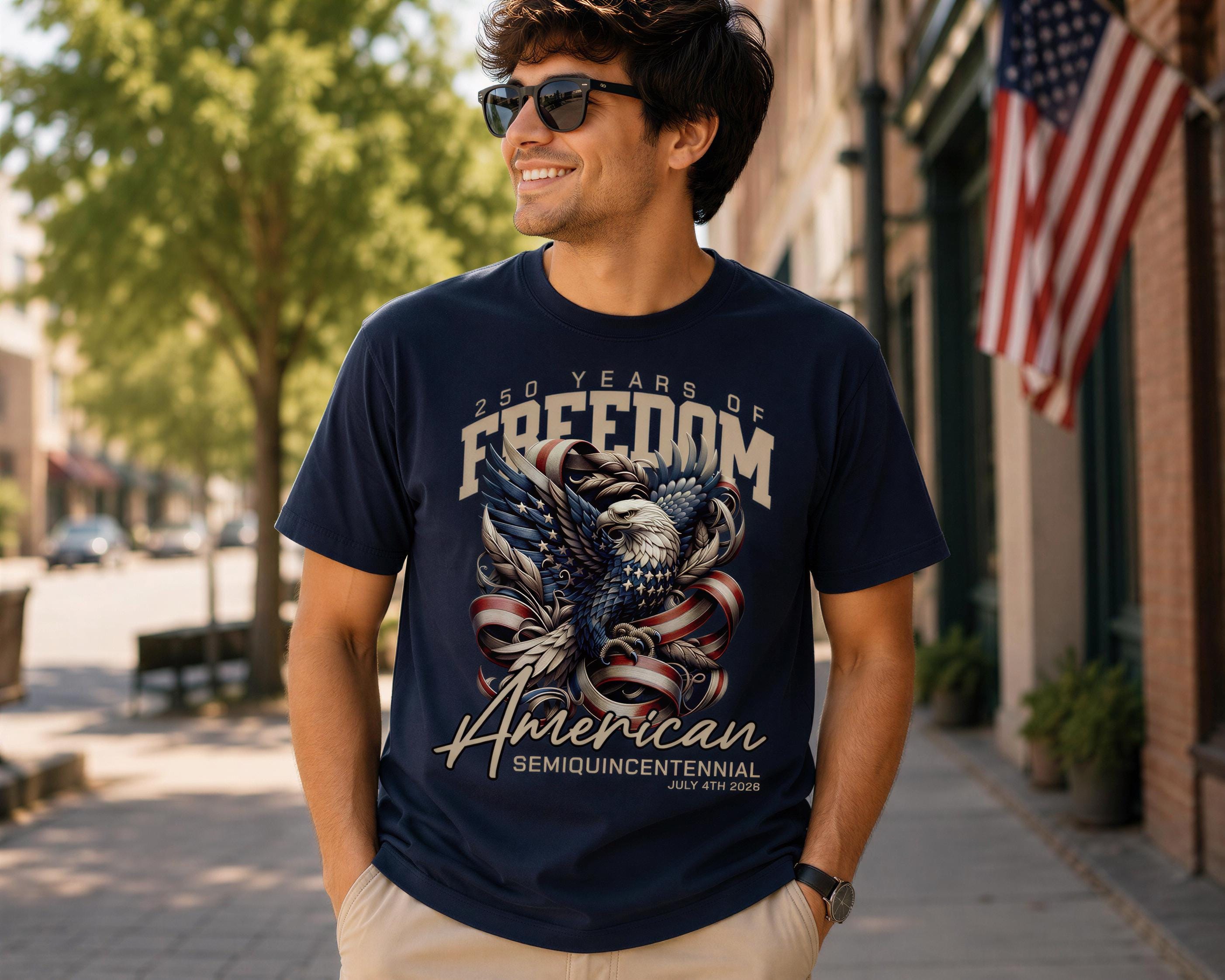 A man wearing a navy blue t-shirt with an eagle design and text that says "50 YEARS OF FREEDOM AMERICAN SEMIQUINCENTENNIAL JULY 4, 2020".