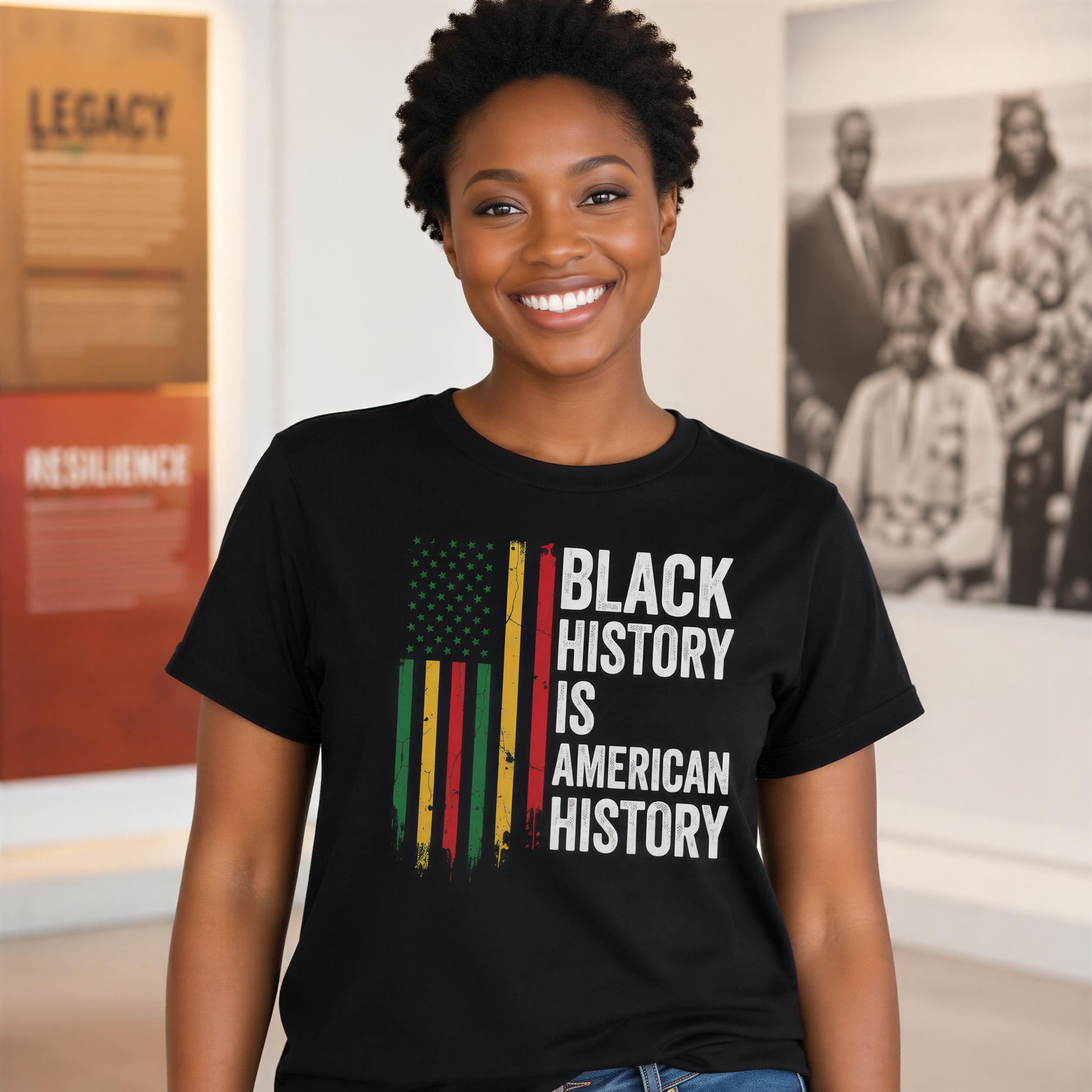 A smiling woman wearing a black t-shirt with the text "Black History is American History" printed on it.