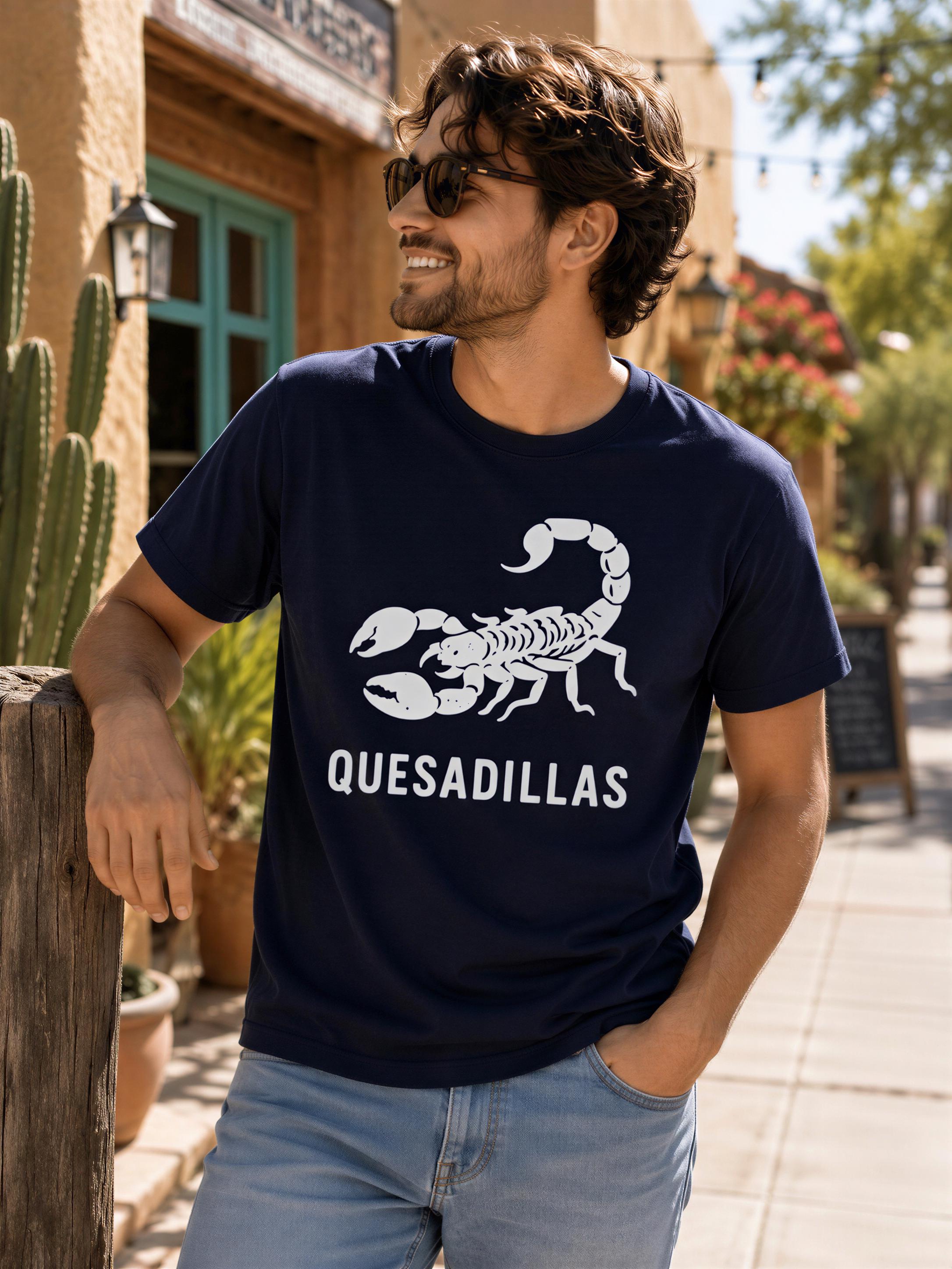 A man wearing a navy blue t-shirt with a white graphic of a scorpion and the text "Quesadillas" is standing on a sidewalk.