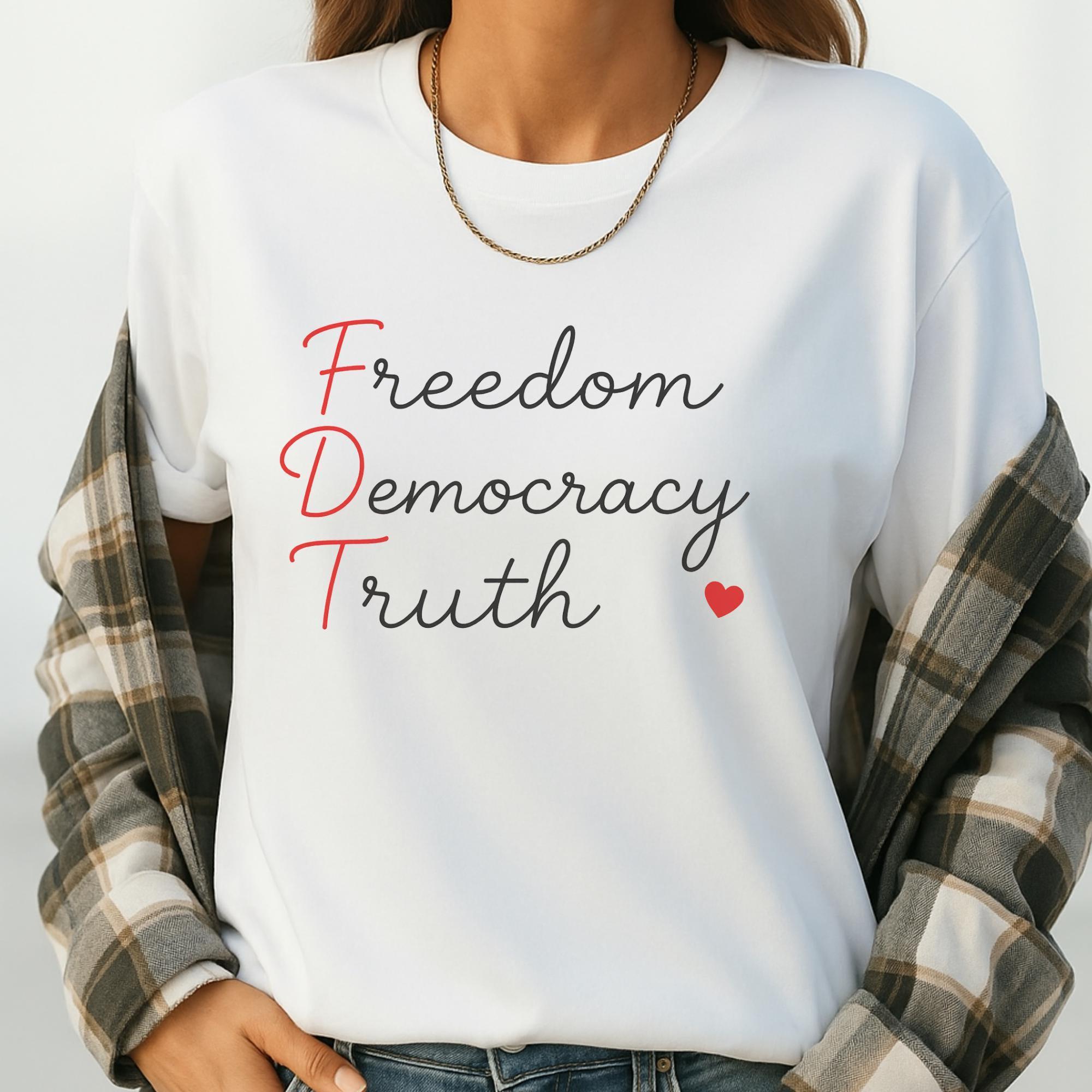 A person wearing a white t-shirt with the text "Freedom Democracy Truth" printed on it.