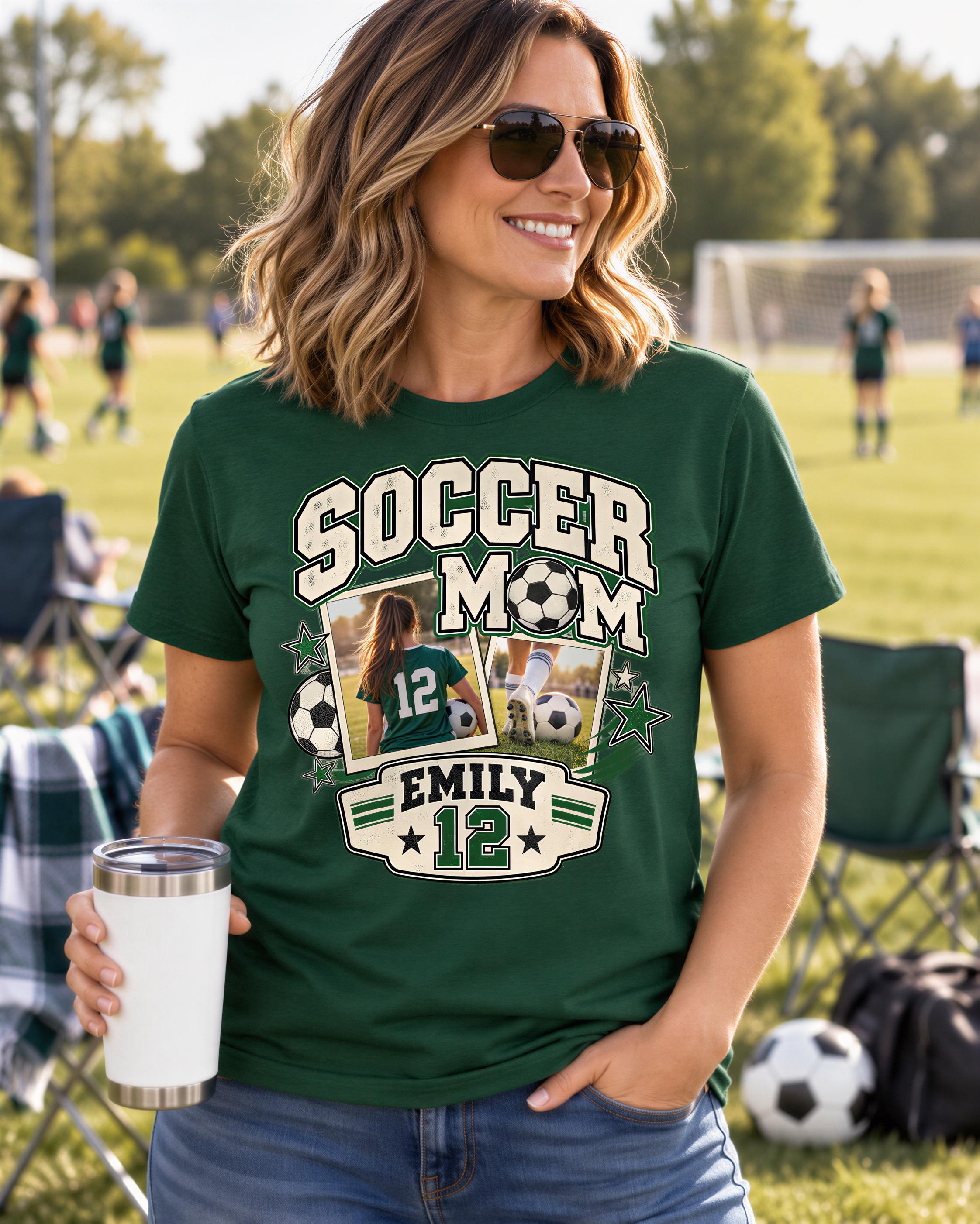 A woman wearing a green t-shirt with a soccer-themed design, including a photo of a young girl and the text "SOCCER MOM EMILY 12". She is holding a white cup and standing in a grassy field with other people and soccer balls in the background.