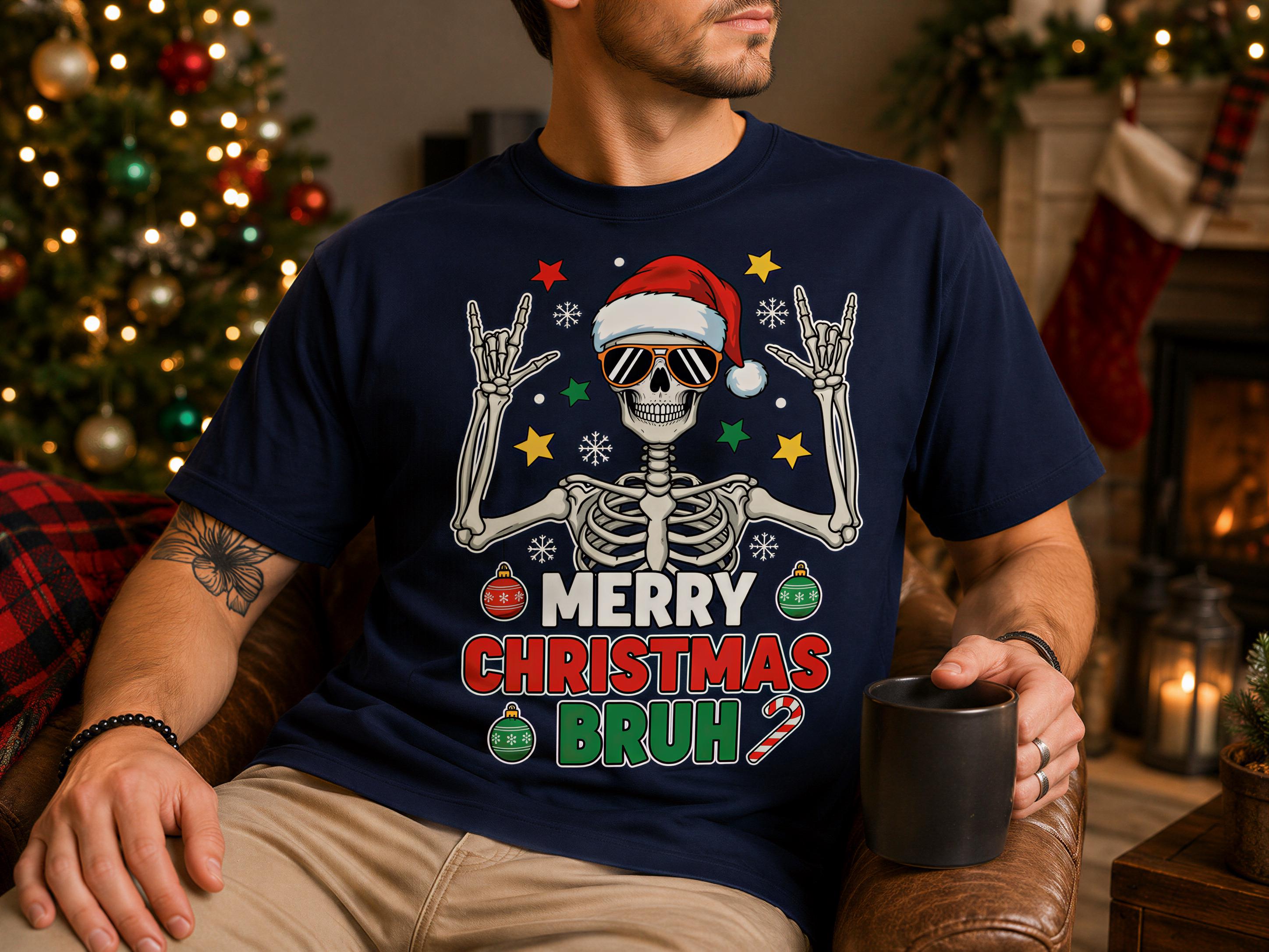 A man wearing a blue t-shirt with a skeleton graphic and text, sitting in a living room with a Christmas tree and stockings visible in the background.