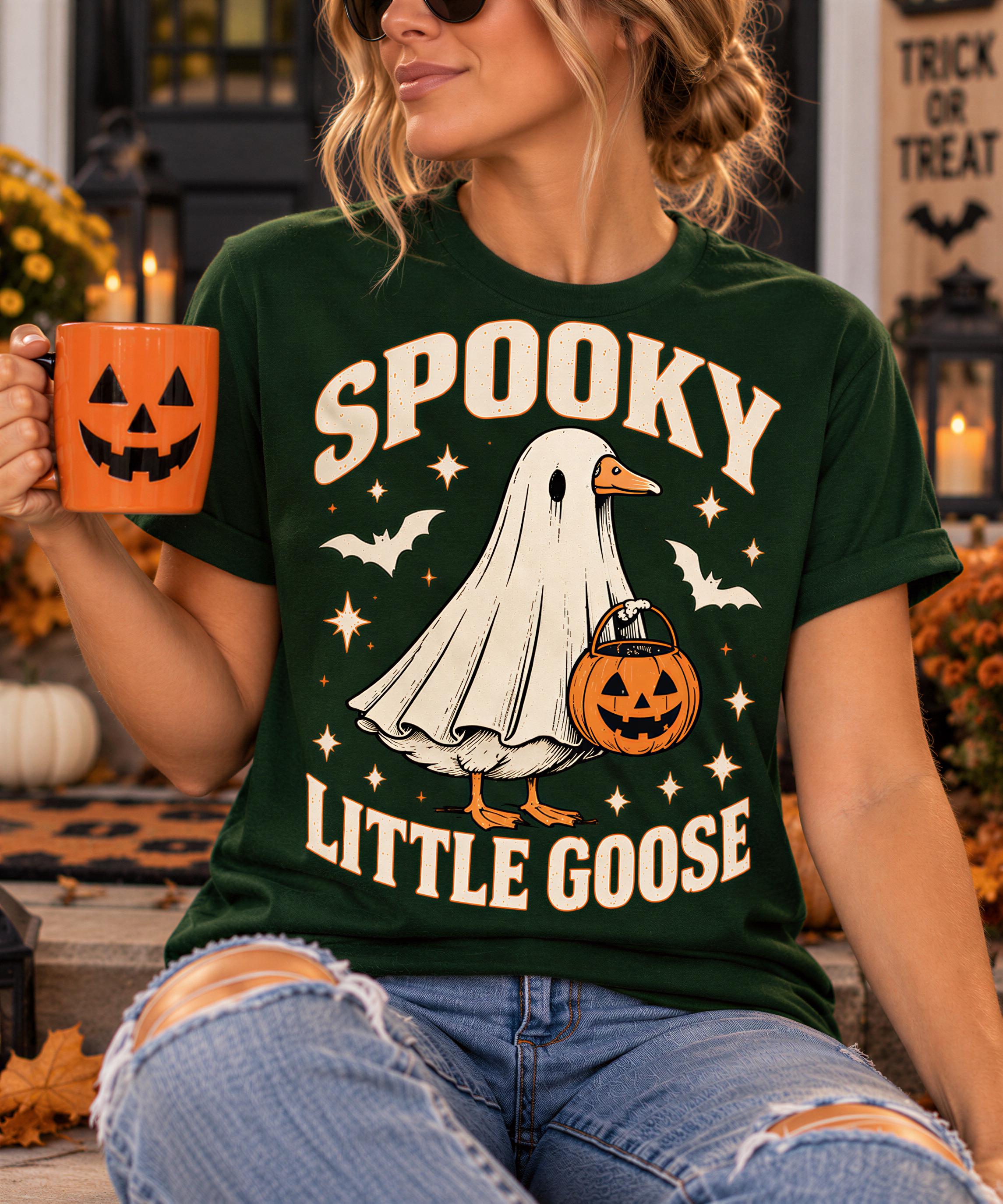 A woman wearing a green t-shirt with a Halloween-themed graphic and holding a mug with a jack-o-lantern design.