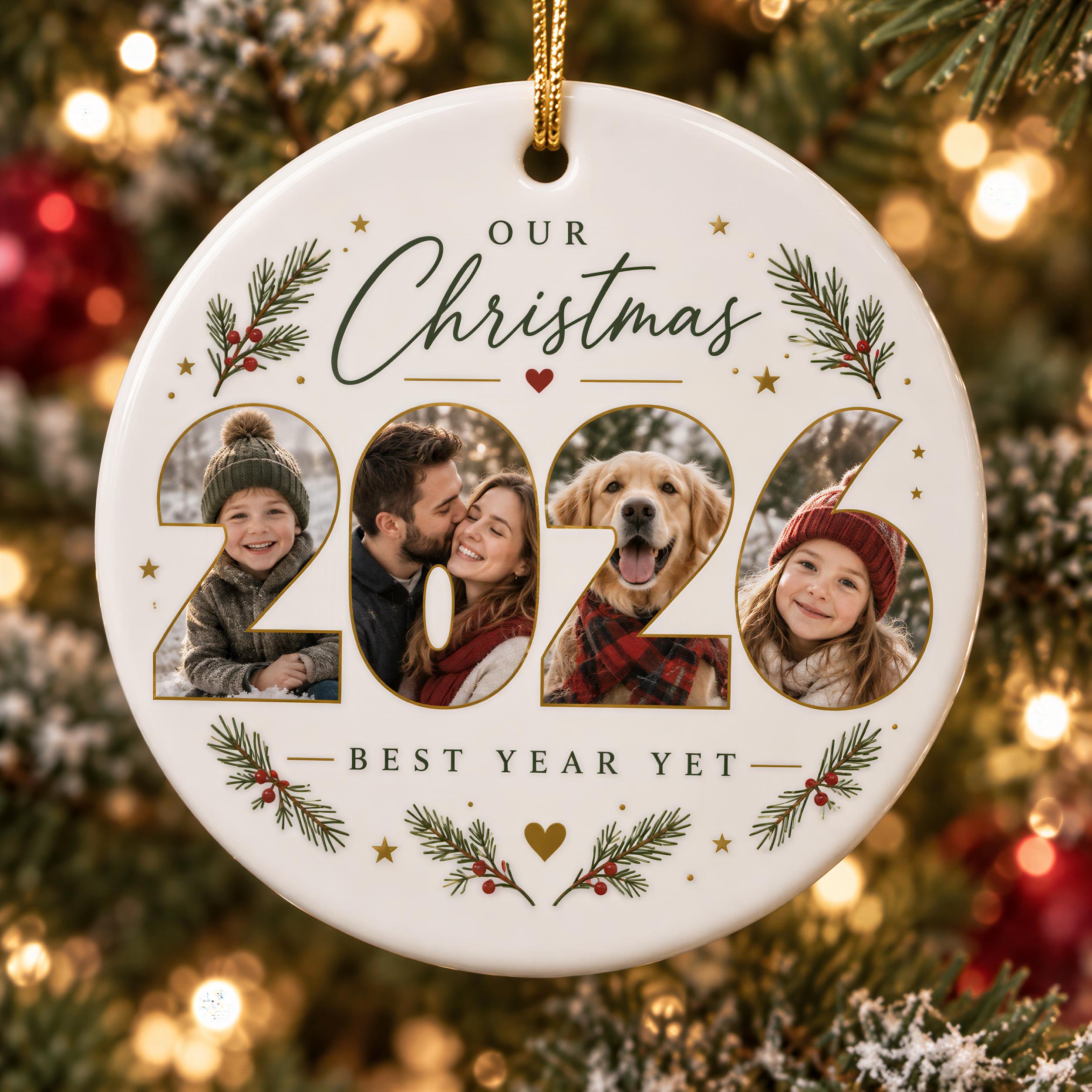 A white ornament with a gold chain hanging on a Christmas tree, featuring a collage of three photos of a family, with the text "OUR CHRISTMAS 2026 BEST YEAR YET" around the images.
