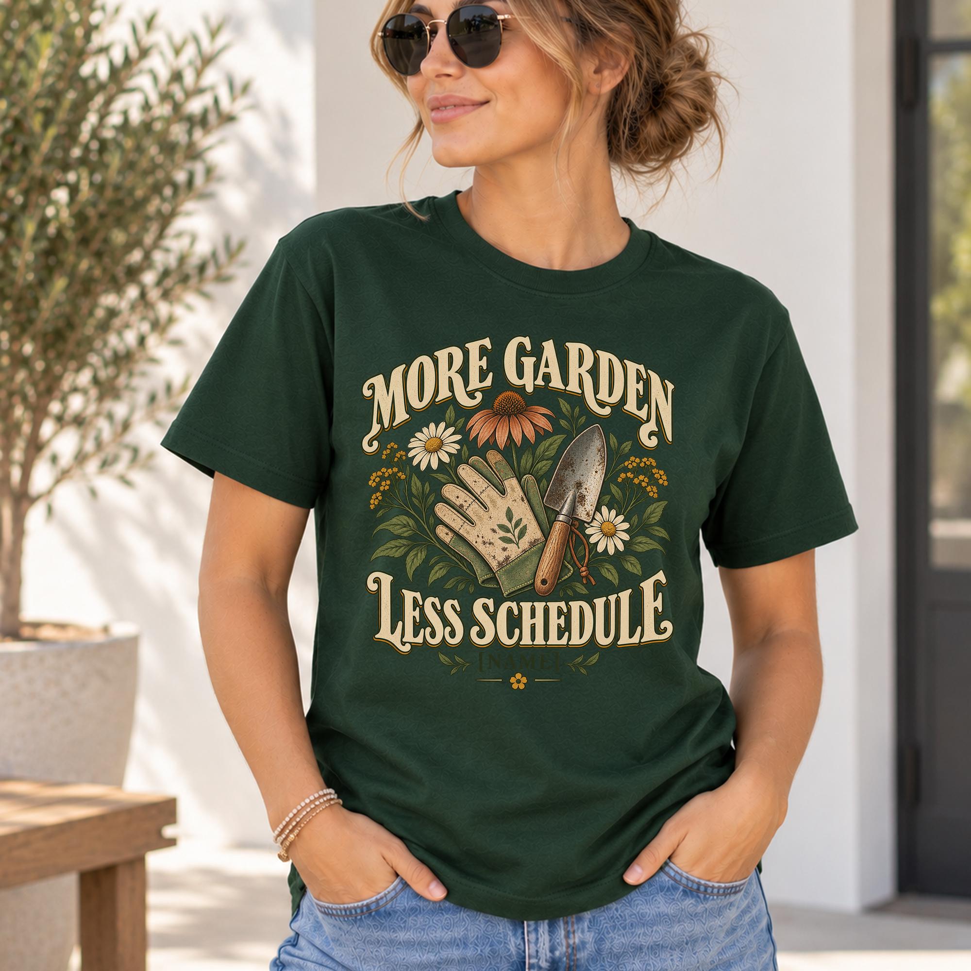 A woman wearing a green t-shirt with a graphic design that says "More Garden Less Schedule" and includes a hand holding a shovel and flowers.