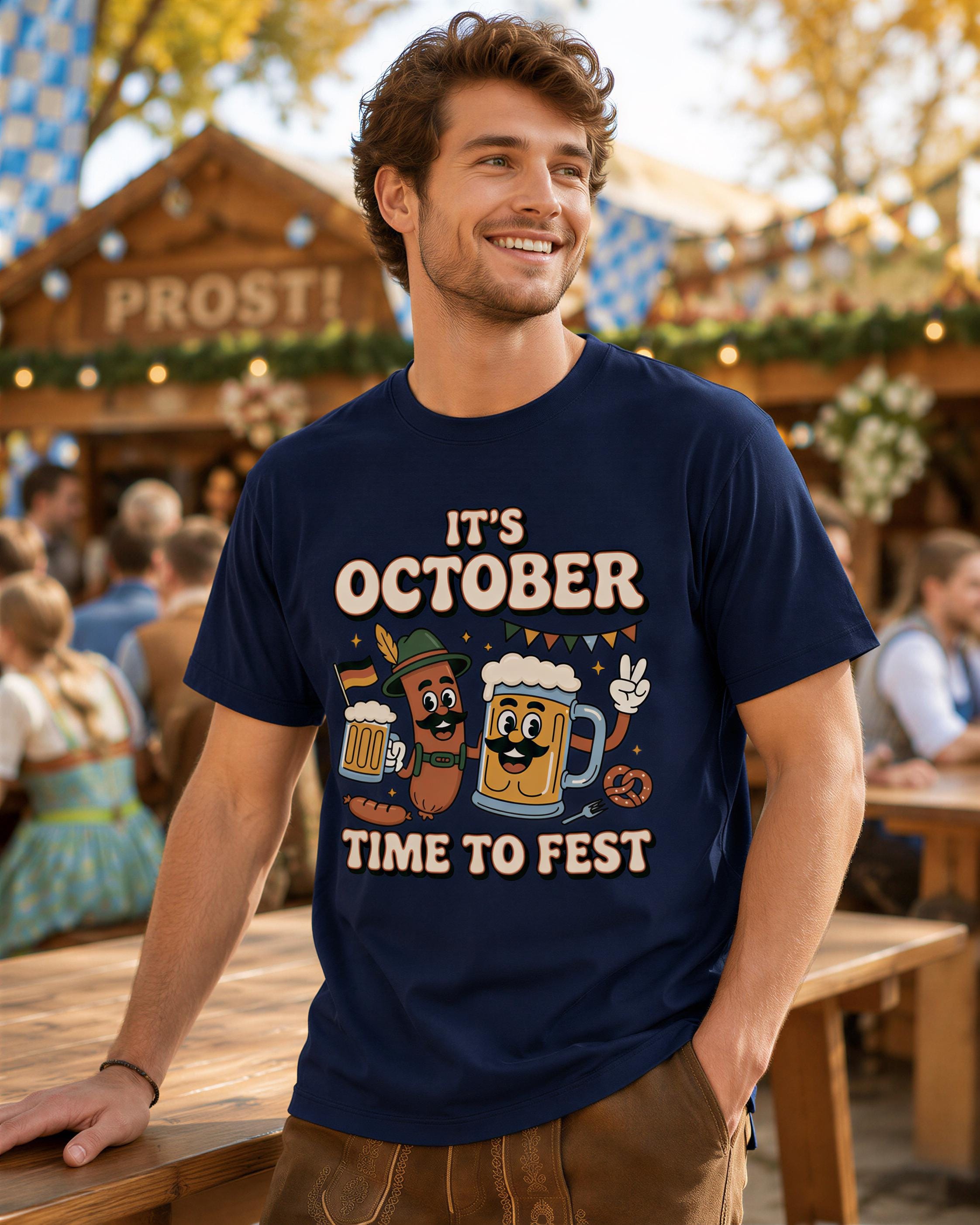 A man wearing a blue t-shirt with a graphic design of cartoon beer cans and the text "It's October Time to Fest" is smiling at the camera.