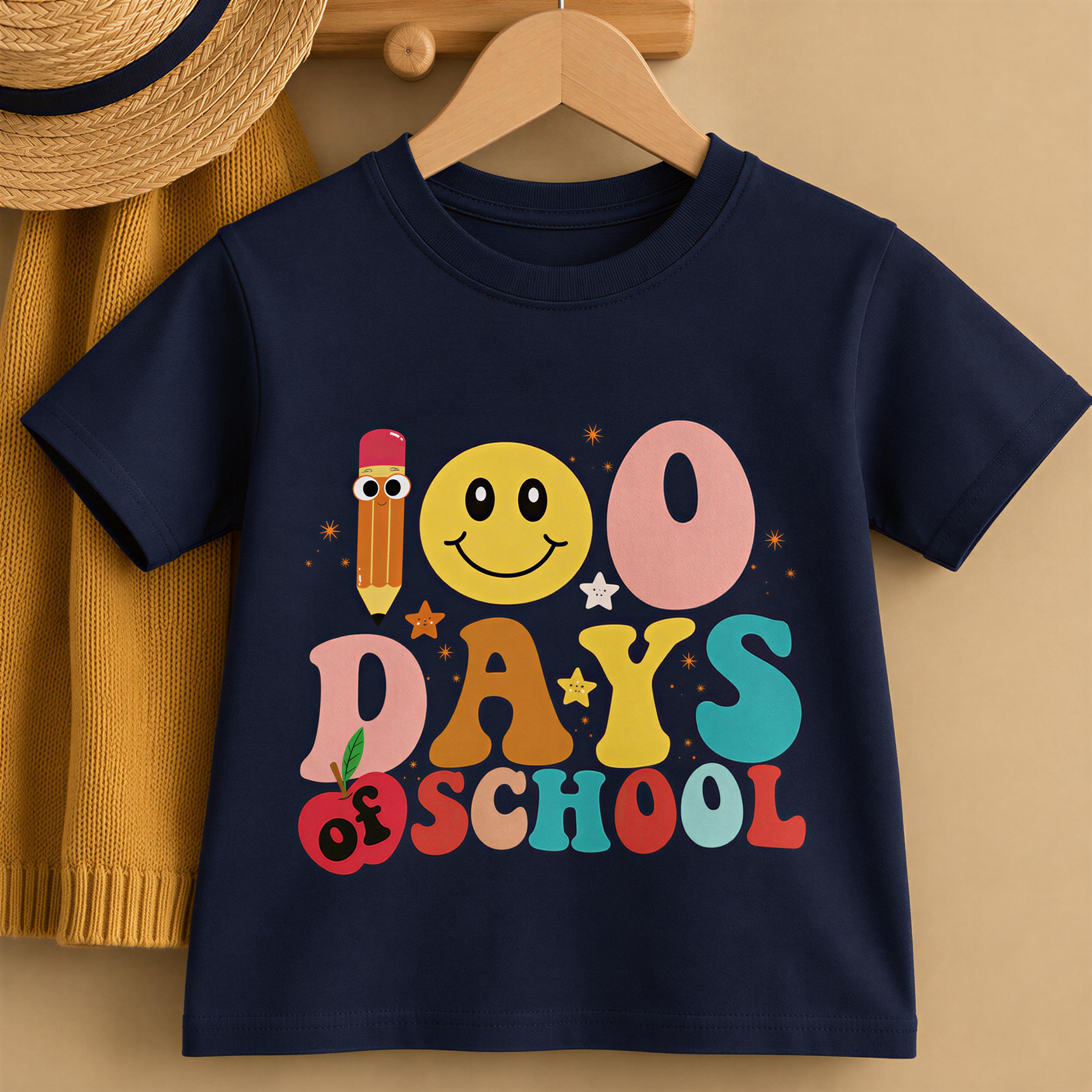 A navy blue t-shirt with a colorful graphic design that says "100 DAYS OF SCHOOL" and features a smiling yellow smiley face, a pencil, and stars.
