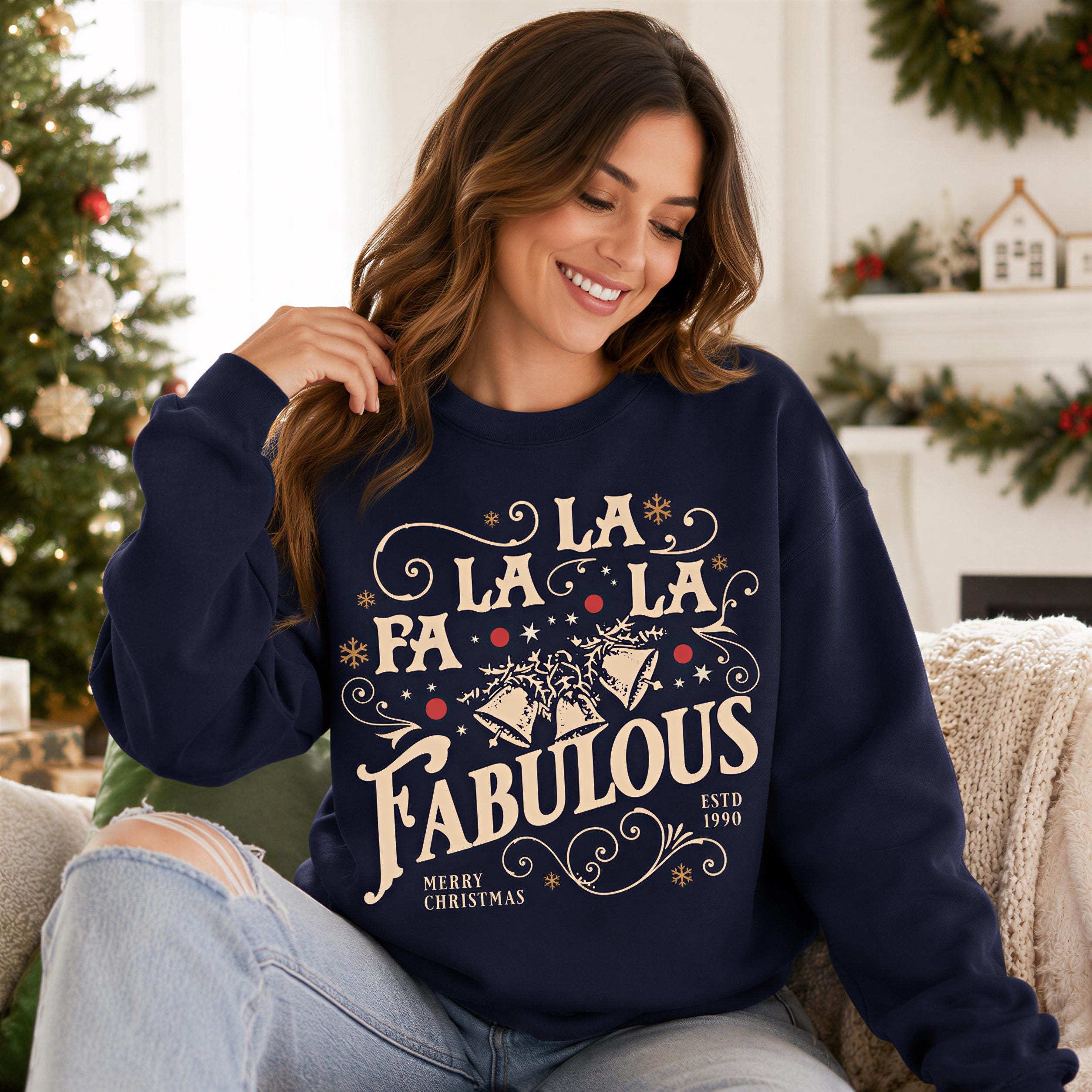 A woman wearing a navy blue sweatshirt with a Christmas-themed design, smiling and posing for the camera.