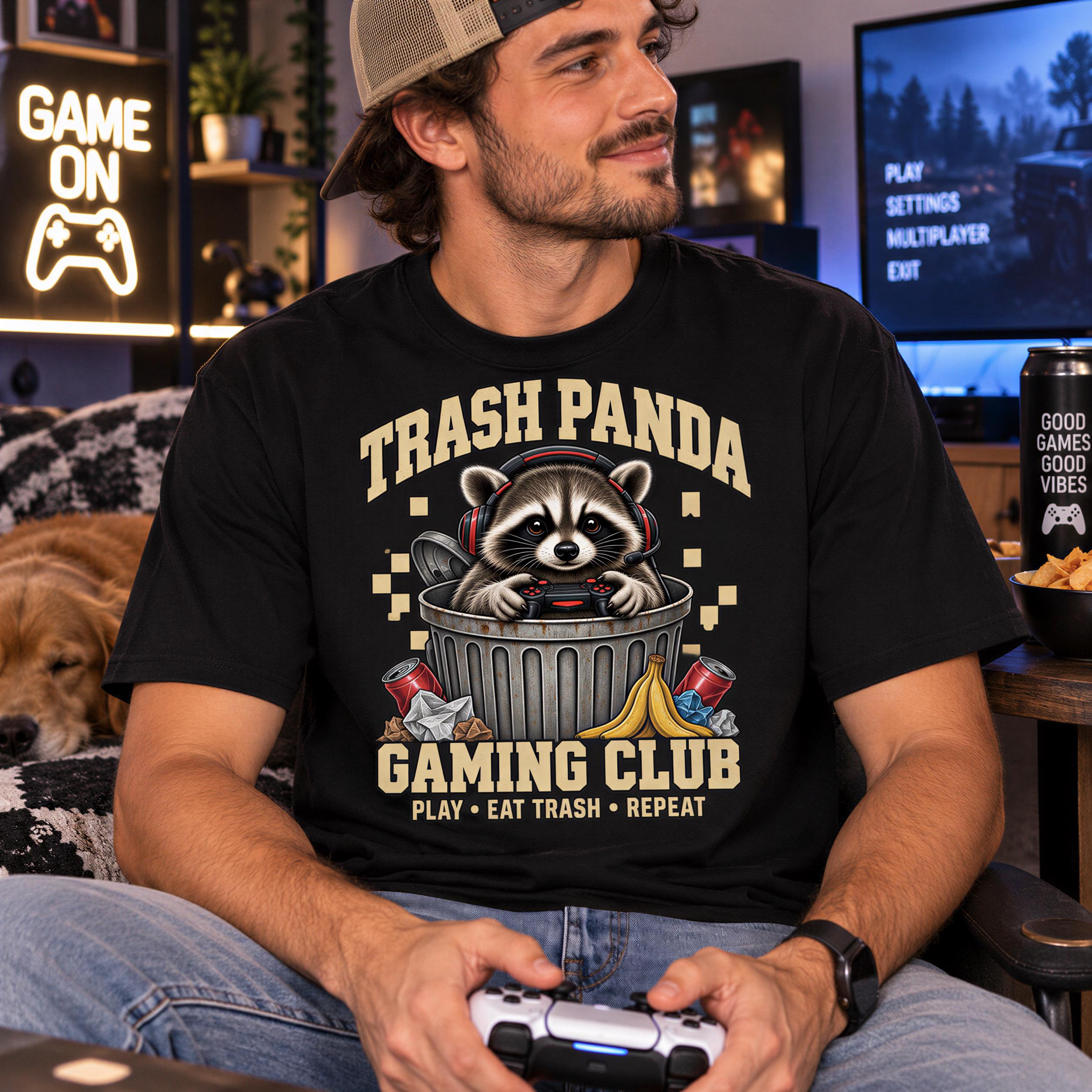A man wearing a black t-shirt with a graphic of a raccoon in a trash can, holding a video game controller, and sitting in a living room with a dog and a TV in the background.